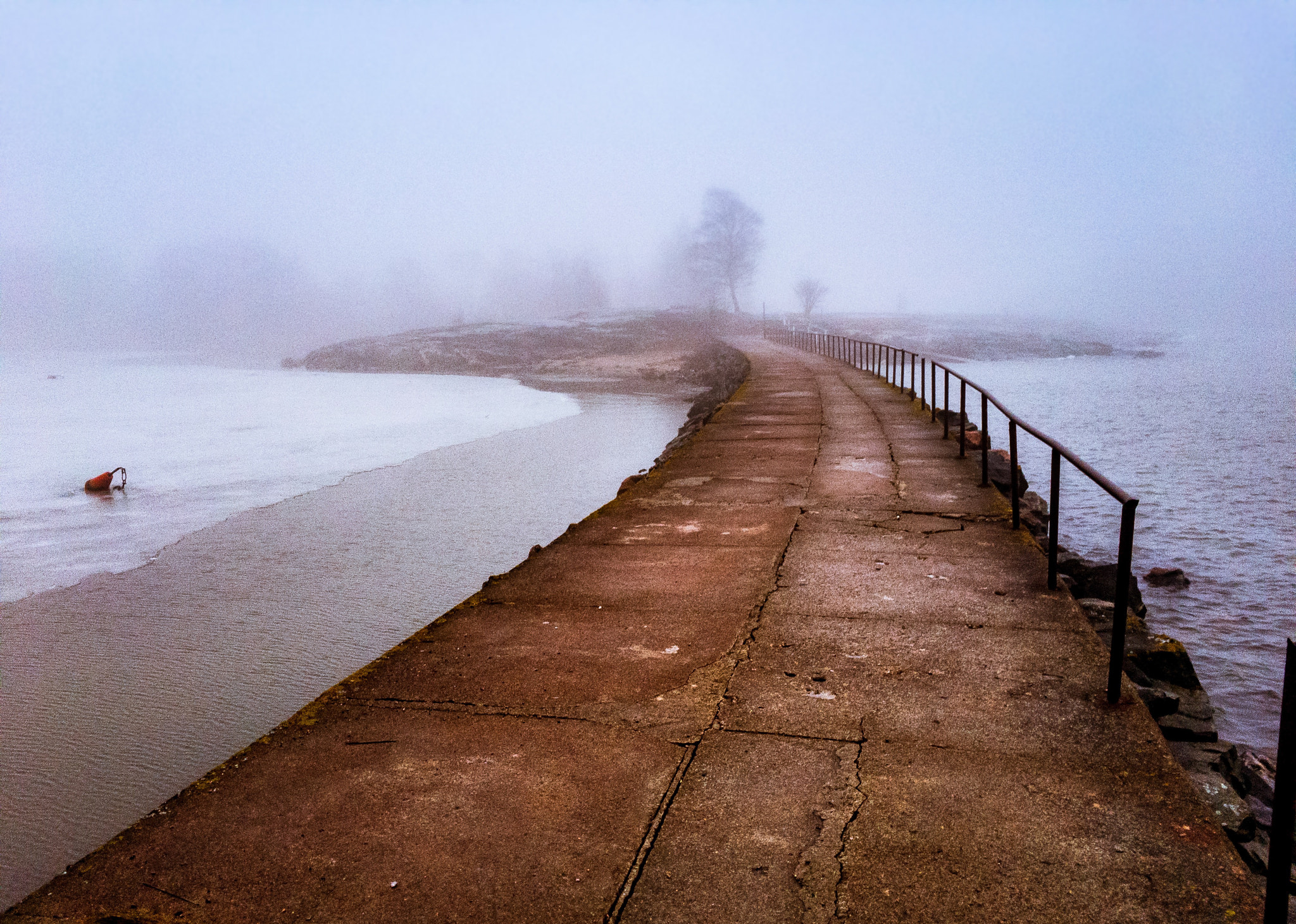 Apple iPhone sample photo. Bridge over to misty island covered by heavy sea fog. photography