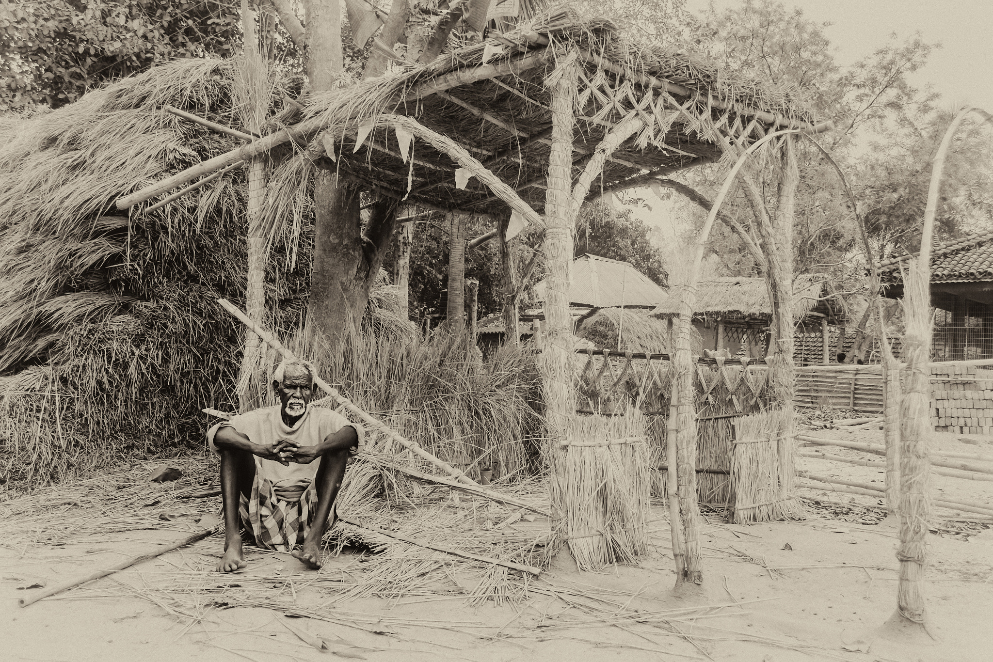 Nikon D7200 sample photo. An old tribal man sitting infront of haystack with copy space photography