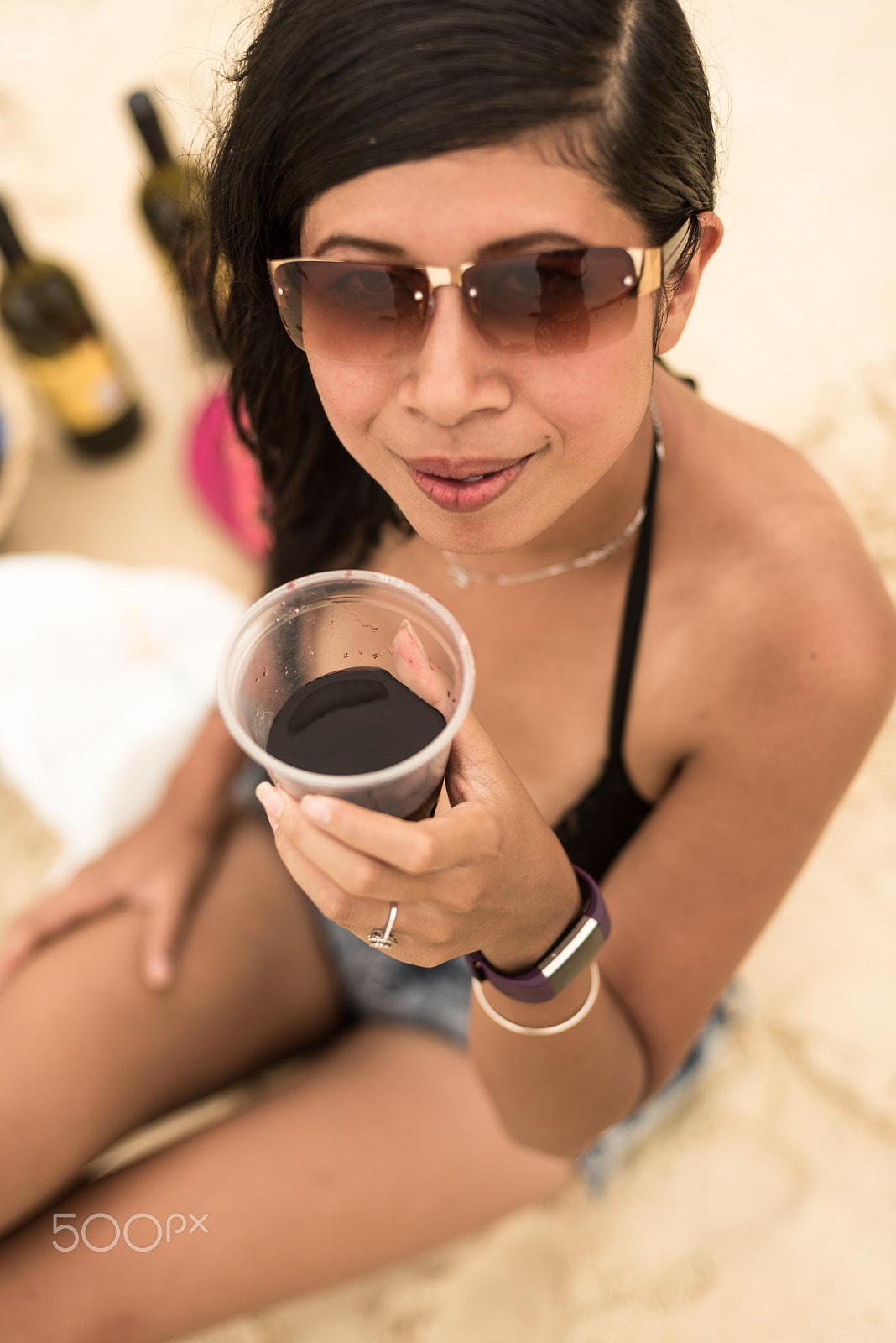 Nikon D750 + Nikon AF Nikkor 50mm F1.4D sample photo. A young pretty woman having red wine at the beach photography