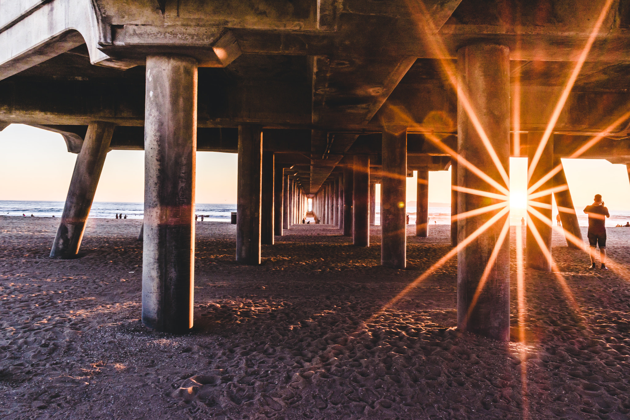 Nikon D5500 + Nikon AF-S Nikkor 20mm F1.8G ED sample photo. Massive starburst under the pier photography