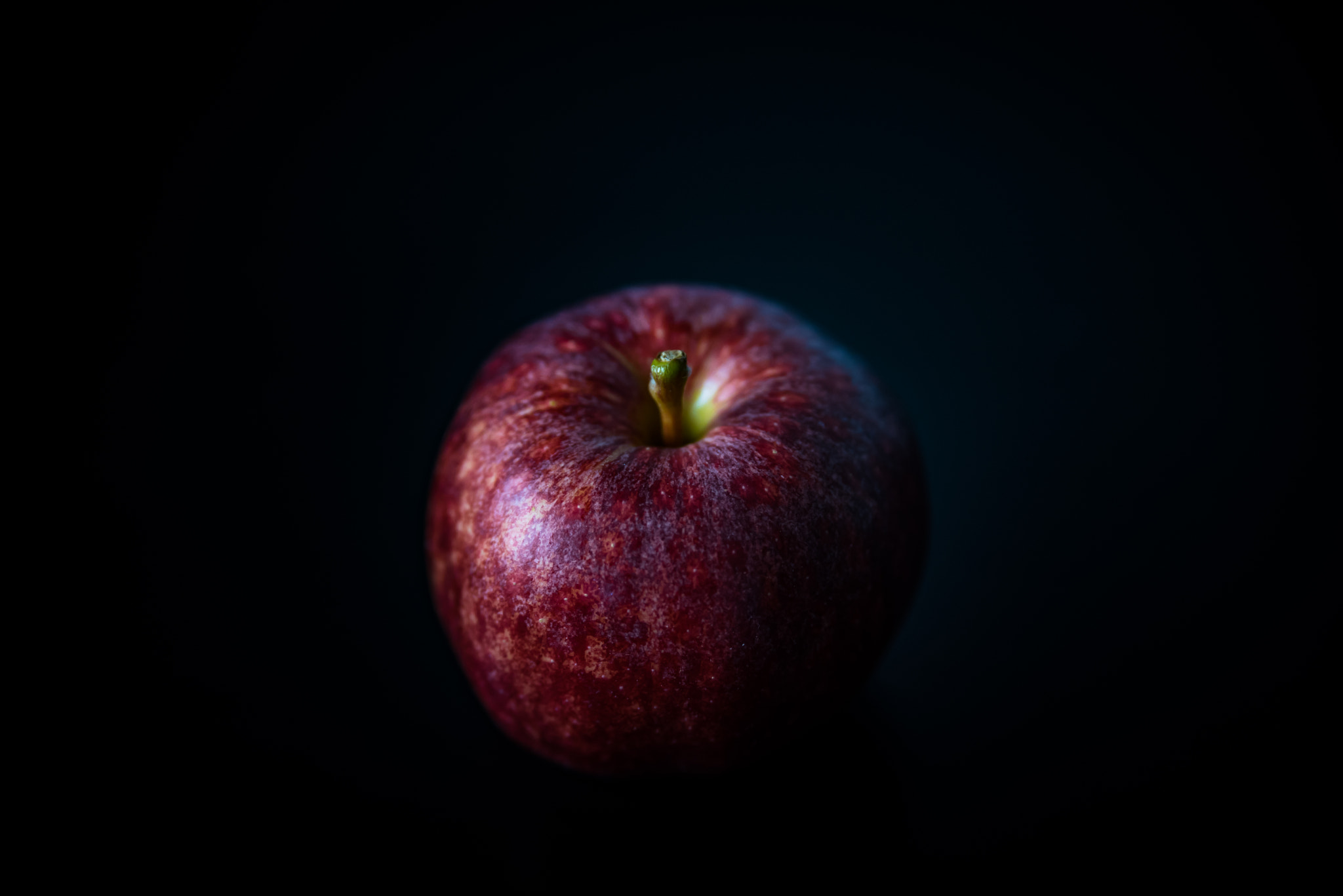 Nikon D750 sample photo. Red apple against black background photography