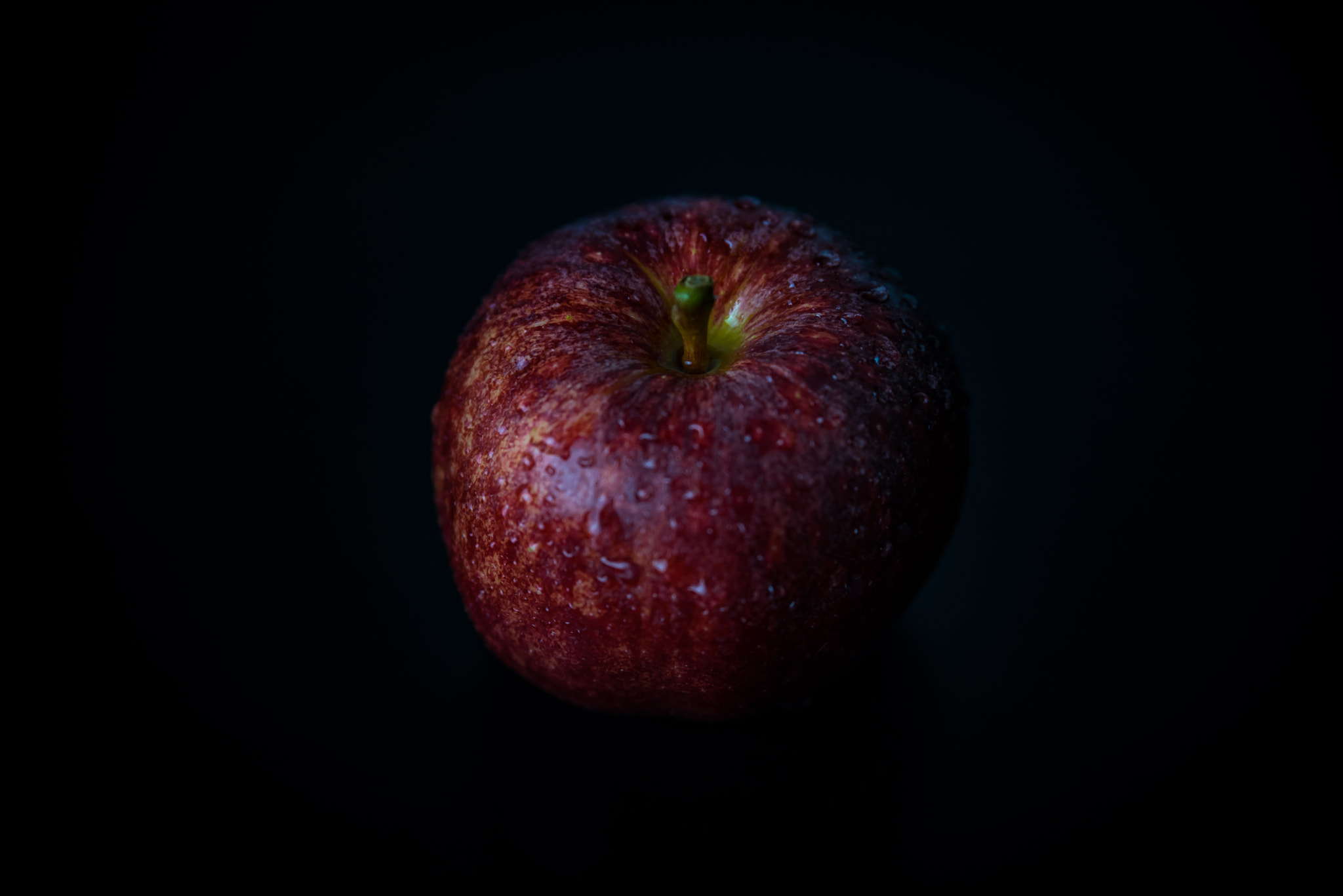 Nikon D750 sample photo. Red apple against black background photography