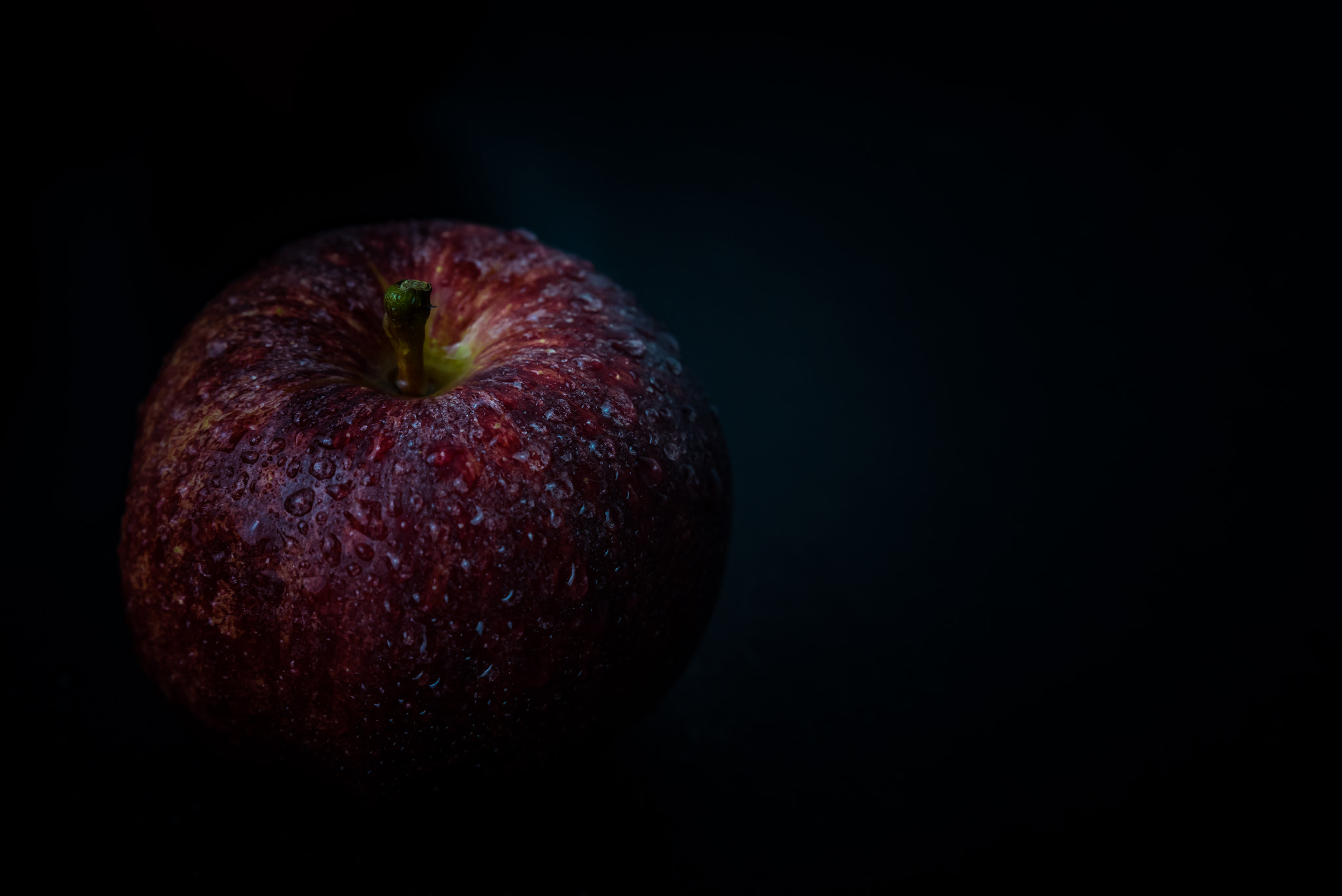 Nikon D750 sample photo. Red apple against black background photography
