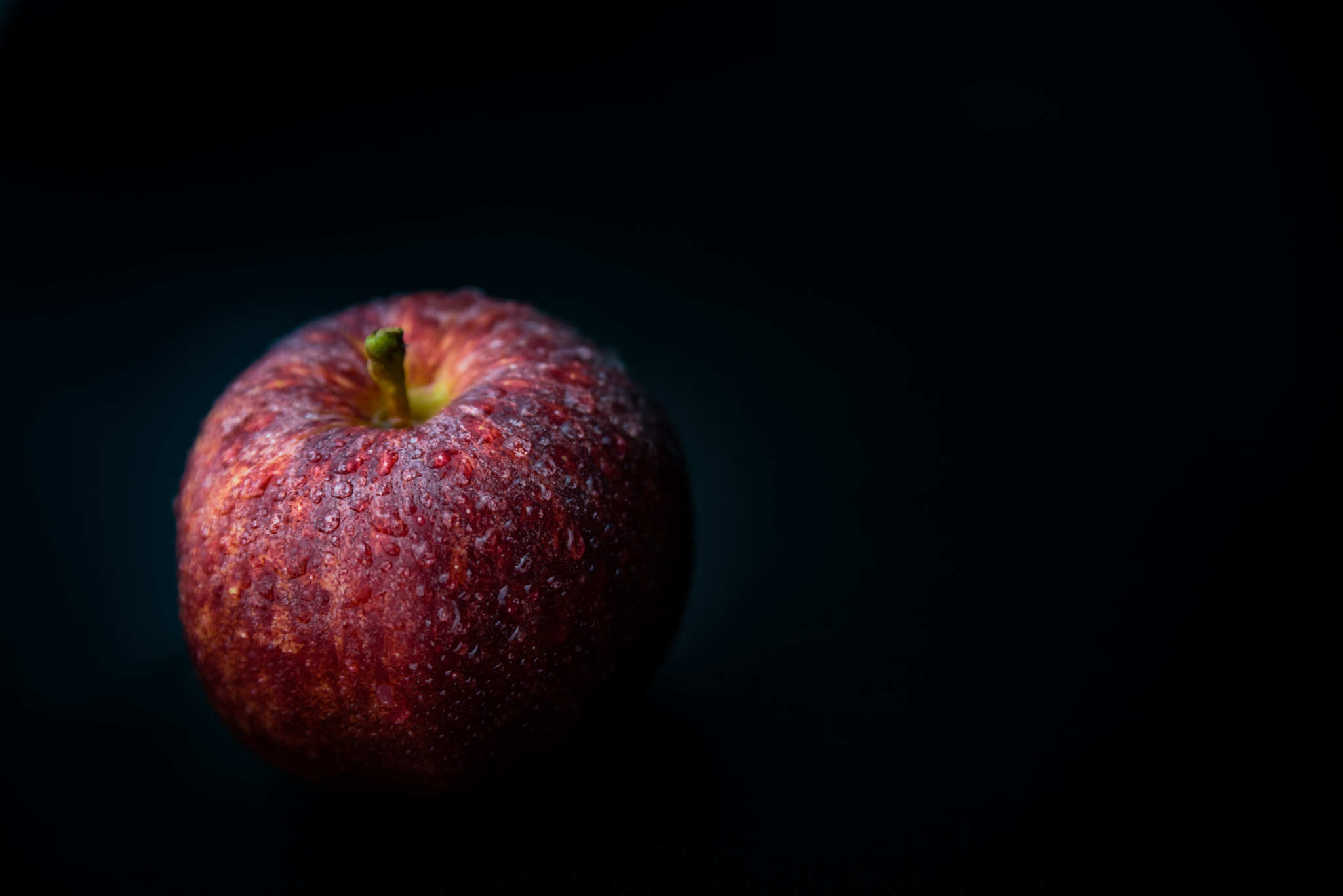 Nikon D750 sample photo. Red apple against black background photography