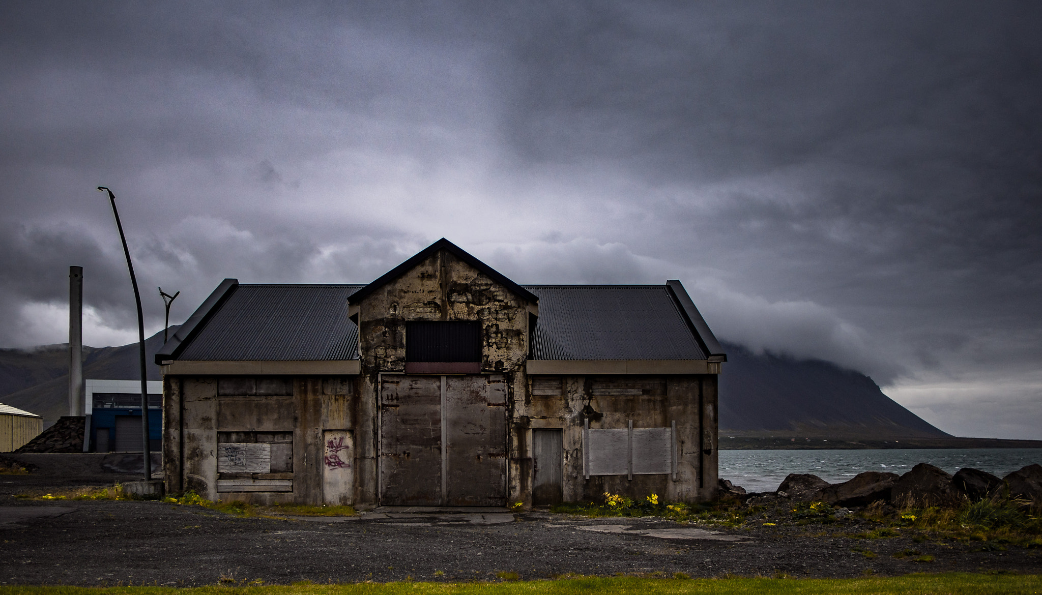 Panasonic Lumix G 14mm F2.5 ASPH sample photo. Old building and yellow flowers photography