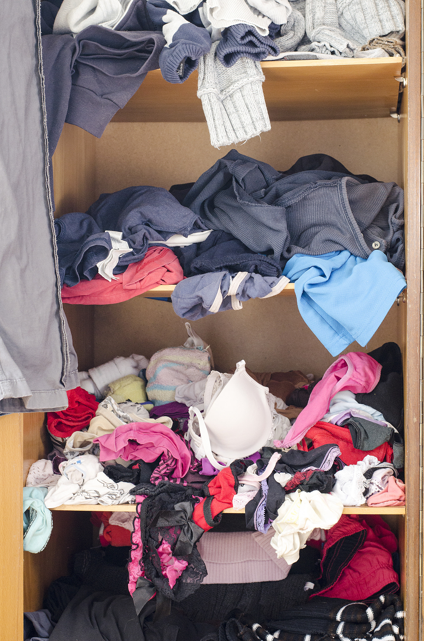Nikon D5100 + Nikon AF-S Nikkor 50mm F1.8G sample photo. Pile of carelessly scattered clothes in wardrobe photography