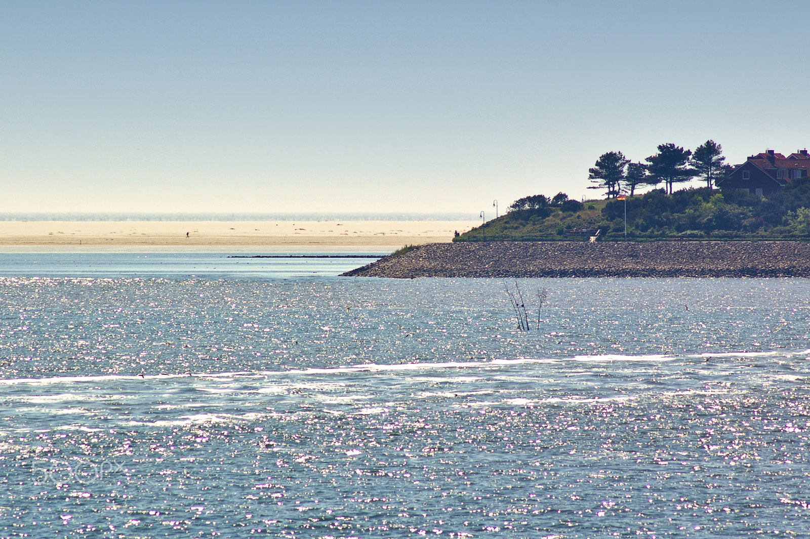 Pentax K100D sample photo. Seashore with trees, house and huge sand bank in the distance photography