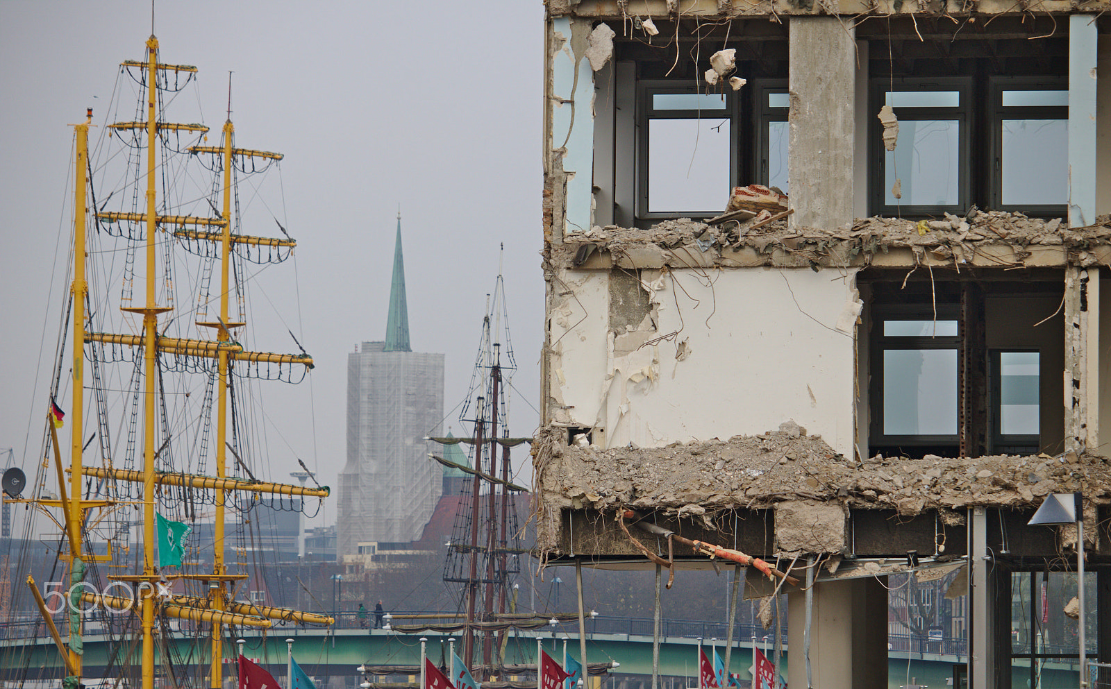 Canon EF-S 55-250mm F4-5.6 IS STM sample photo. Demolished office building with sailship in the background photography