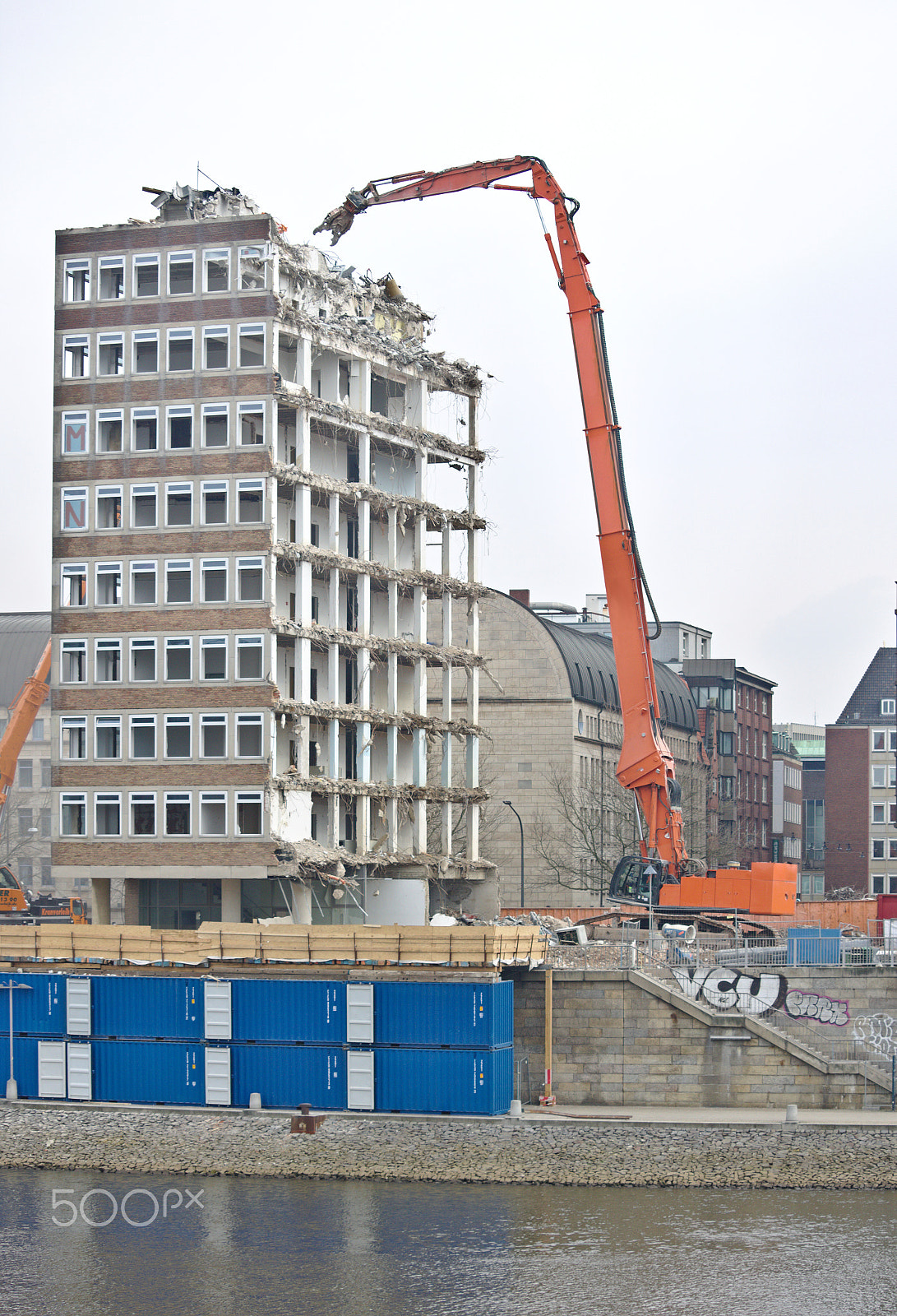 Canon EF-S 55-250mm F4-5.6 IS STM sample photo. Demolished office building with crane, containers photography
