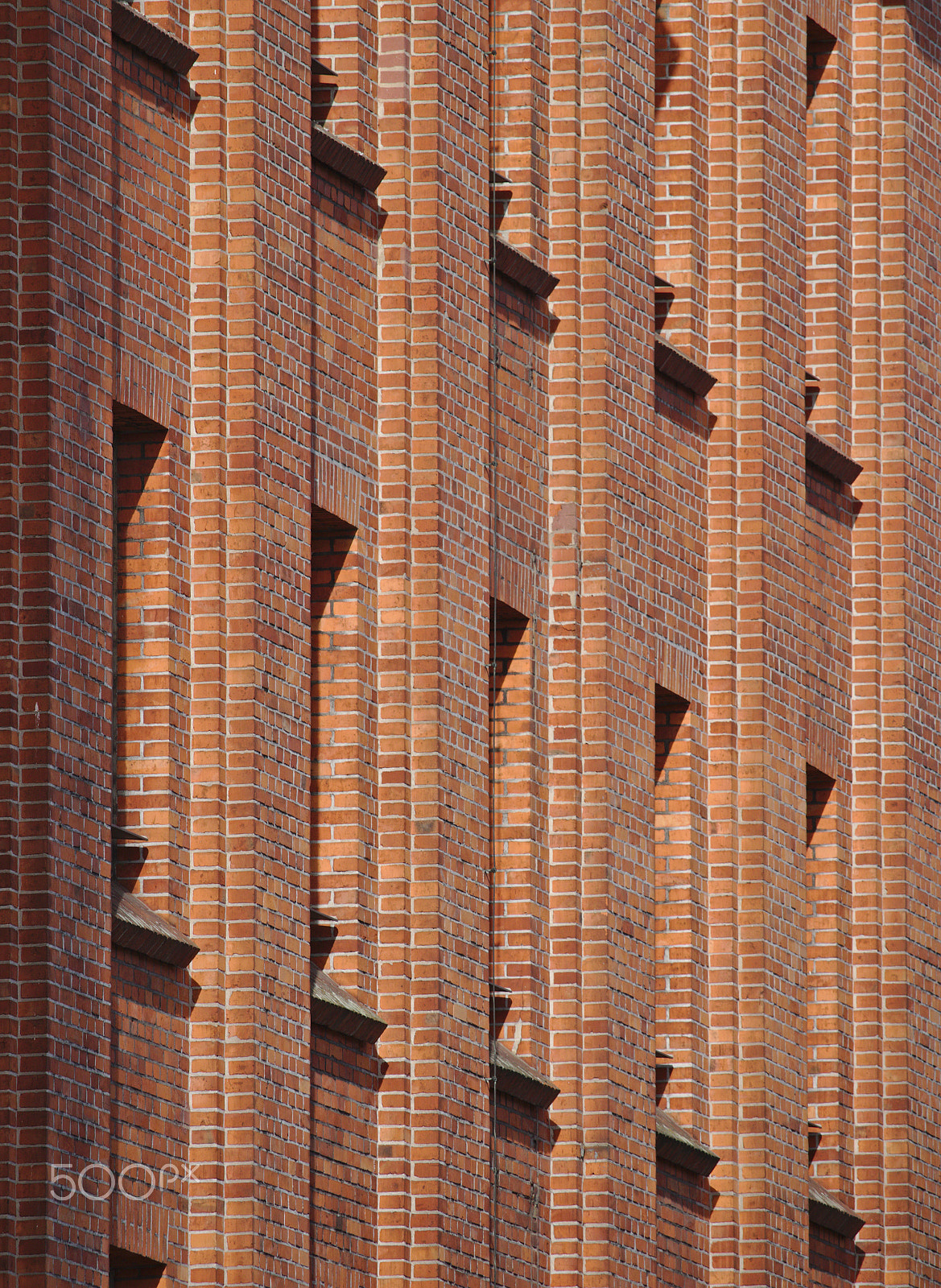 Canon EOS 750D (EOS Rebel T6i / EOS Kiss X8i) sample photo. Red brick wall with row of narrow windows photography