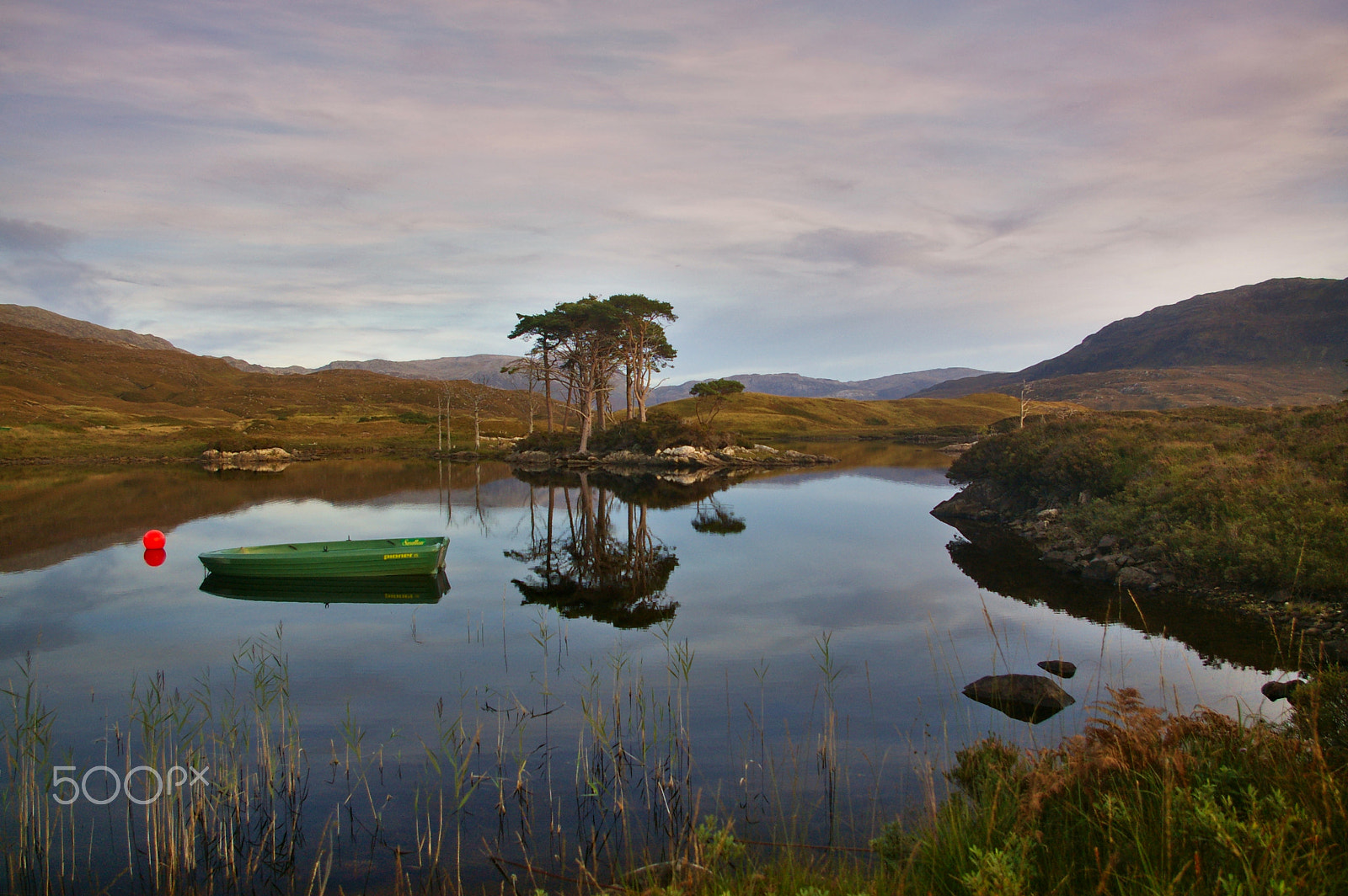 Pentax K100D + Pentax smc DA 18-55mm F3.5-5.6 AL sample photo. Loch assynt at sunset with boat, trees, mountains, reflections in the water photography