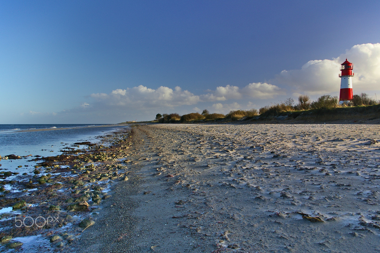 Pentax K100D sample photo. Beach with lighthouse, sky, clouds photography