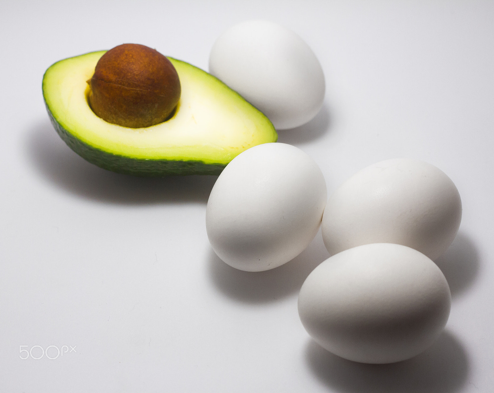 Canon EOS 7D + Canon EF 50mm F1.8 STM sample photo. Avocado egg white background photography