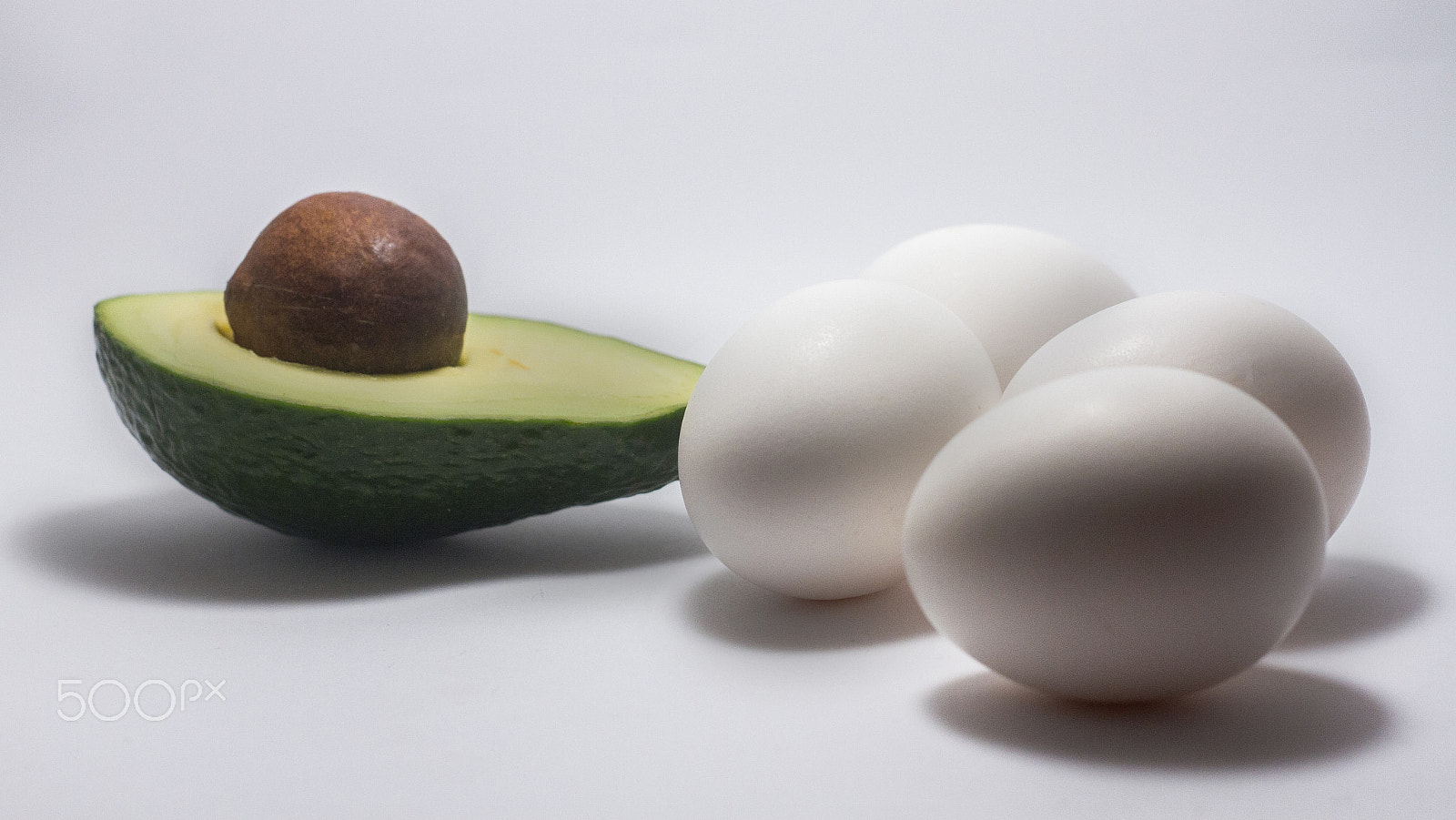 Canon EOS 7D + Canon EF 50mm F1.8 STM sample photo. Avocado egg white background photography