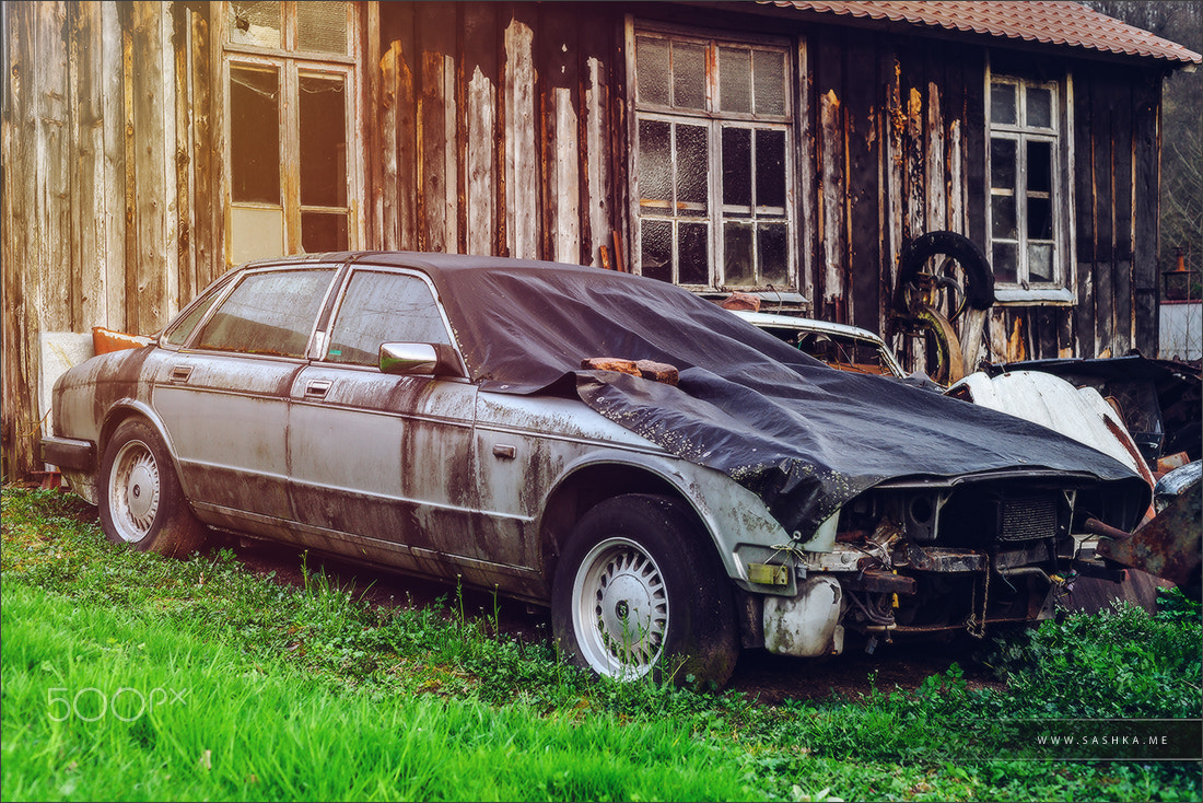 Sony a99 II sample photo. Abandoned old rusty body and parts of retro car photography