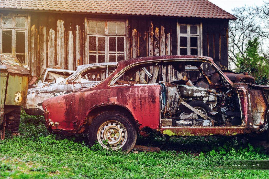 Sony a99 II sample photo. Abandoned old rusty body and parts of retro car photography