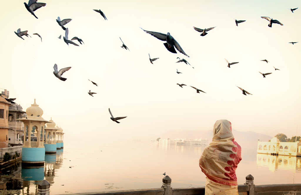 A woman in sari watching the sunrise in Udaipur lake by Gil Kreslavsky on 500px.com