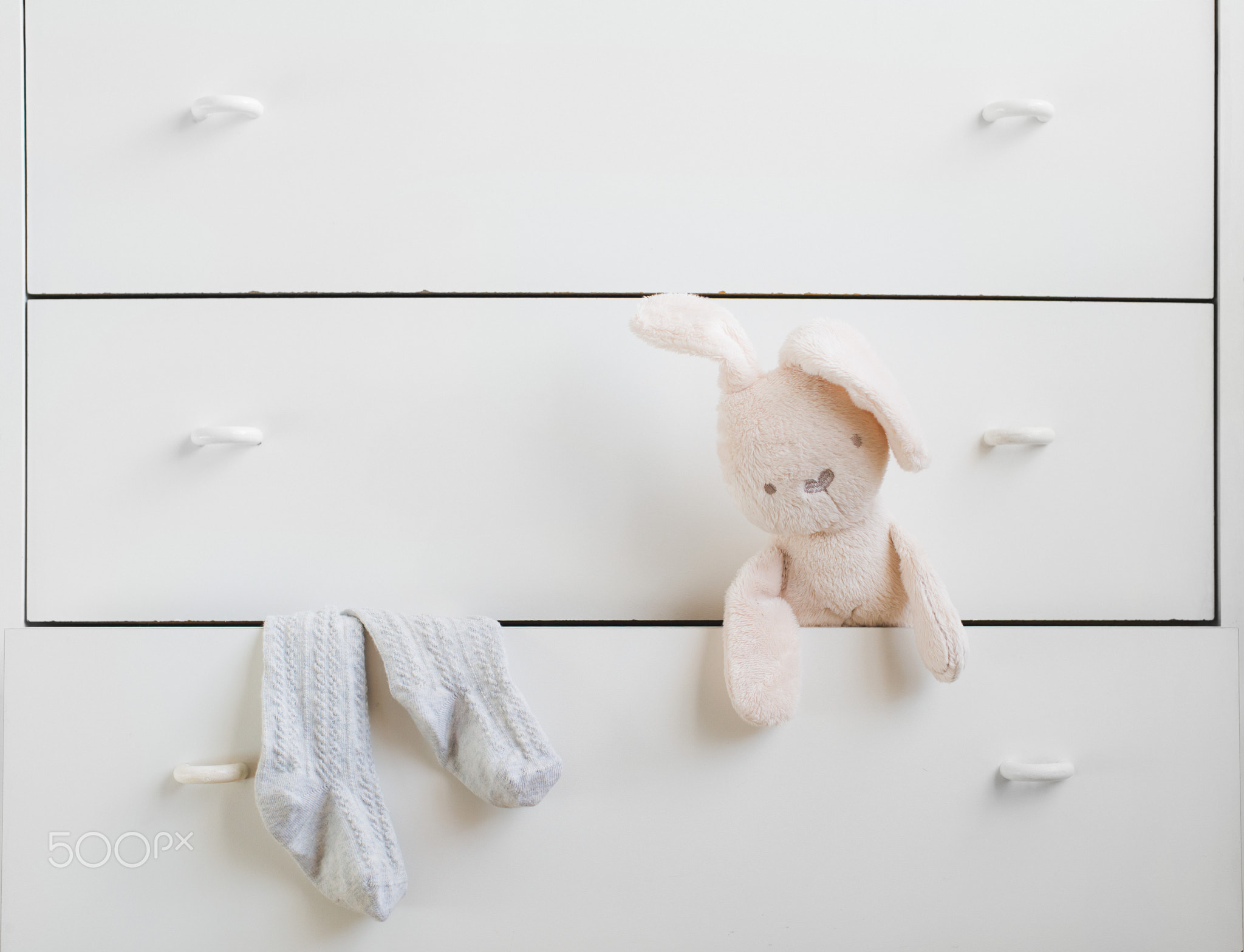 Open shelf of white chest