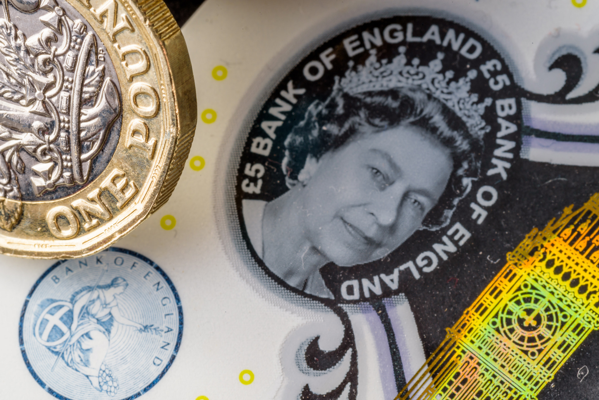 New five sterling pounds note and one pound coin