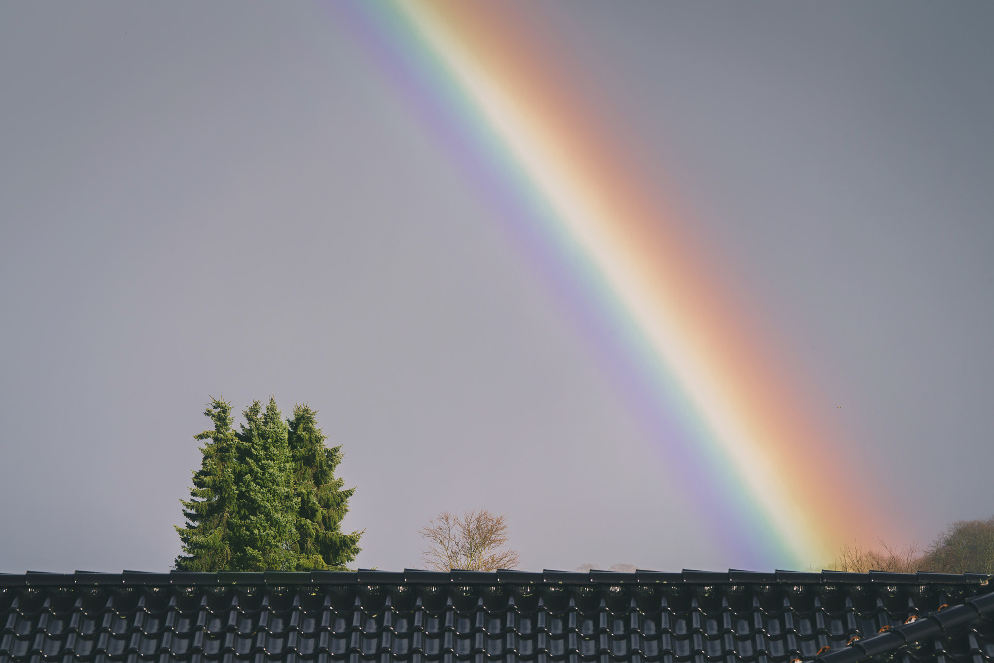 Colorful rainbow over a roof