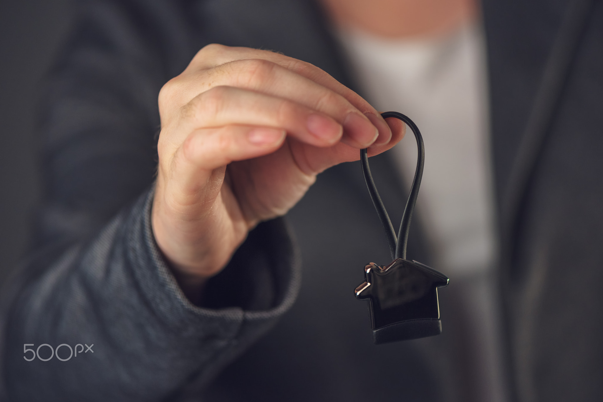 Female real estate agent with house model key ring