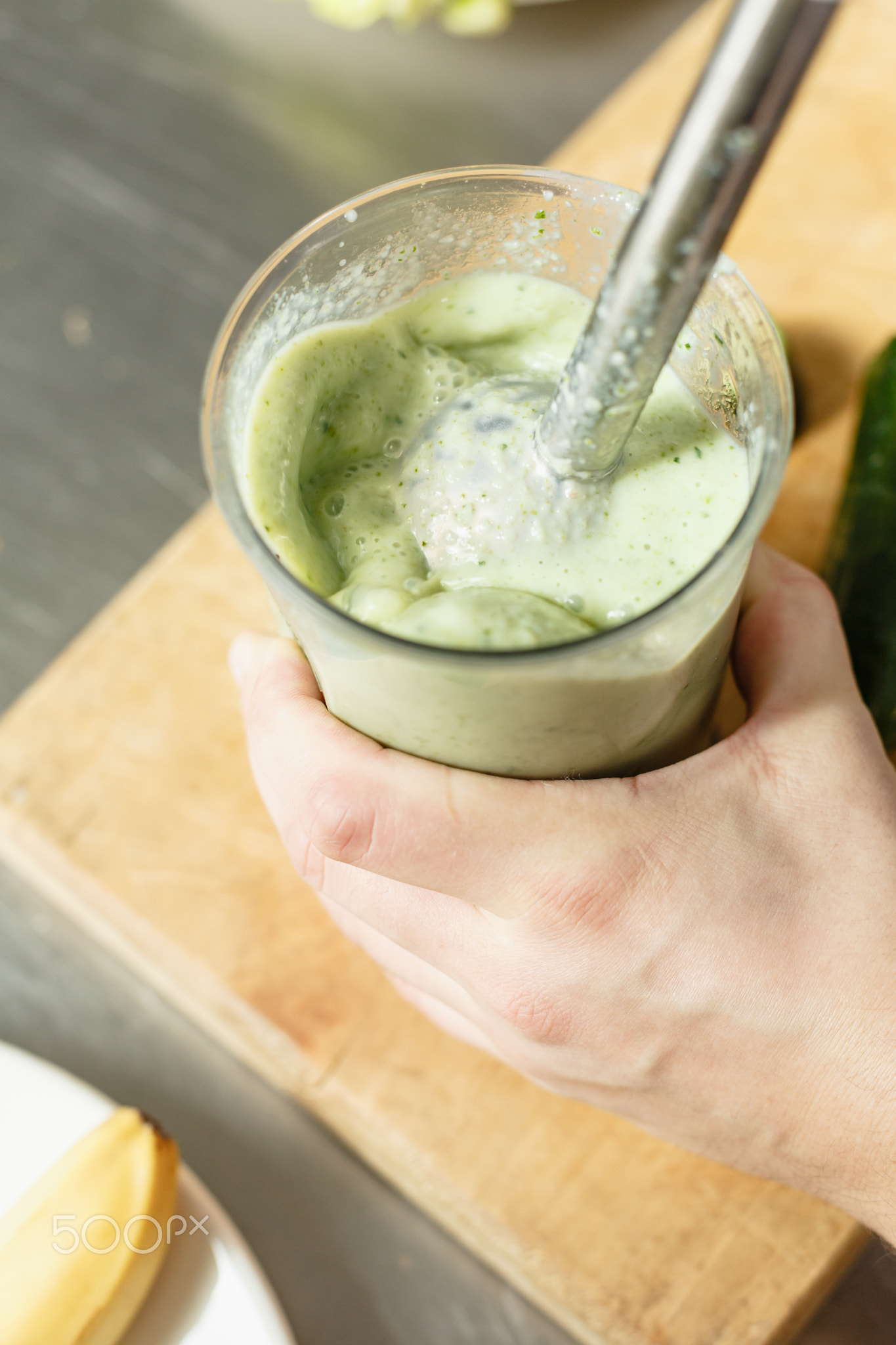 Male chef blending smoothie