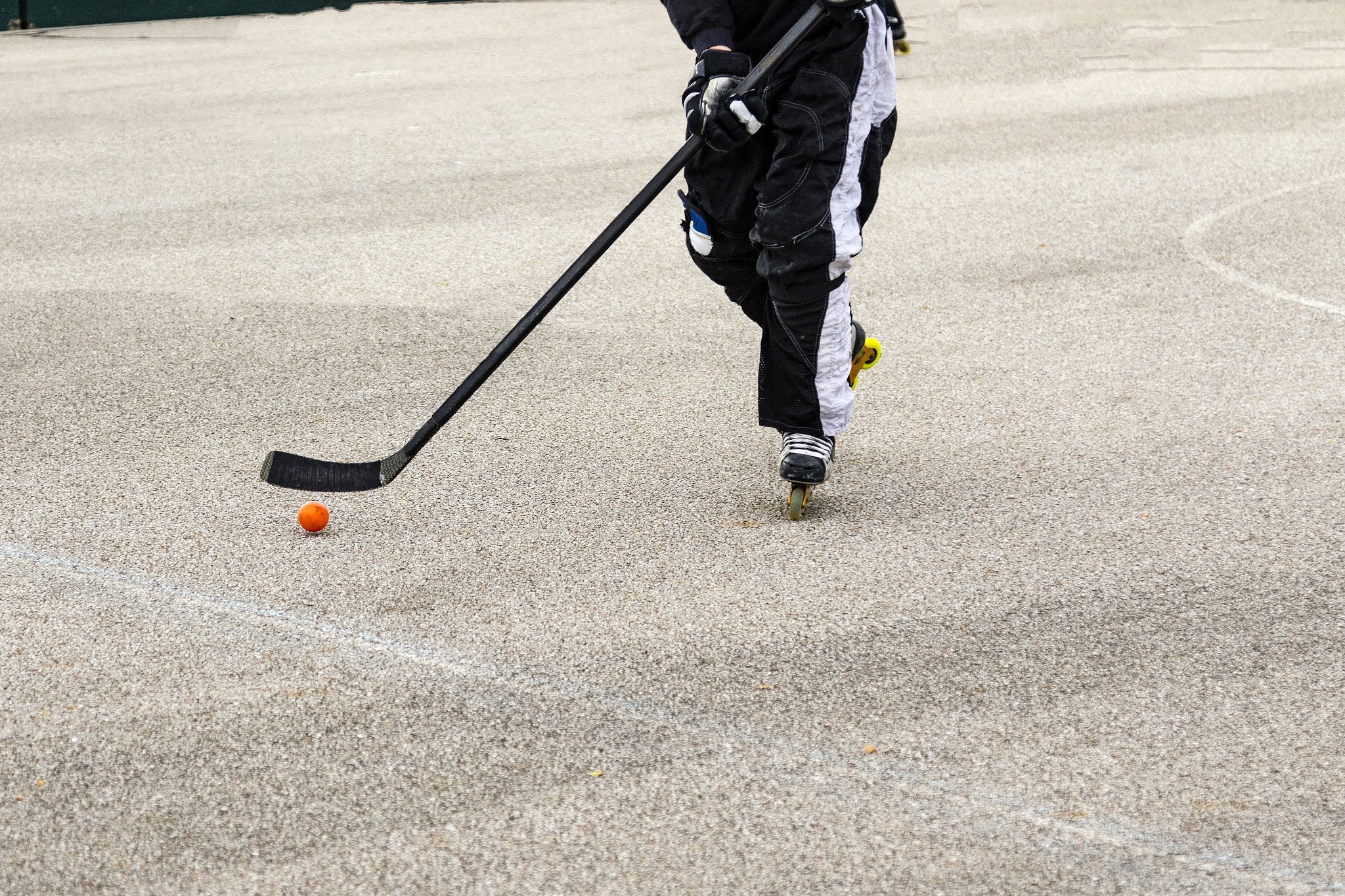 Canon EOS 7D Mark II sample photo. Stick handling the puck to clear the zone photography