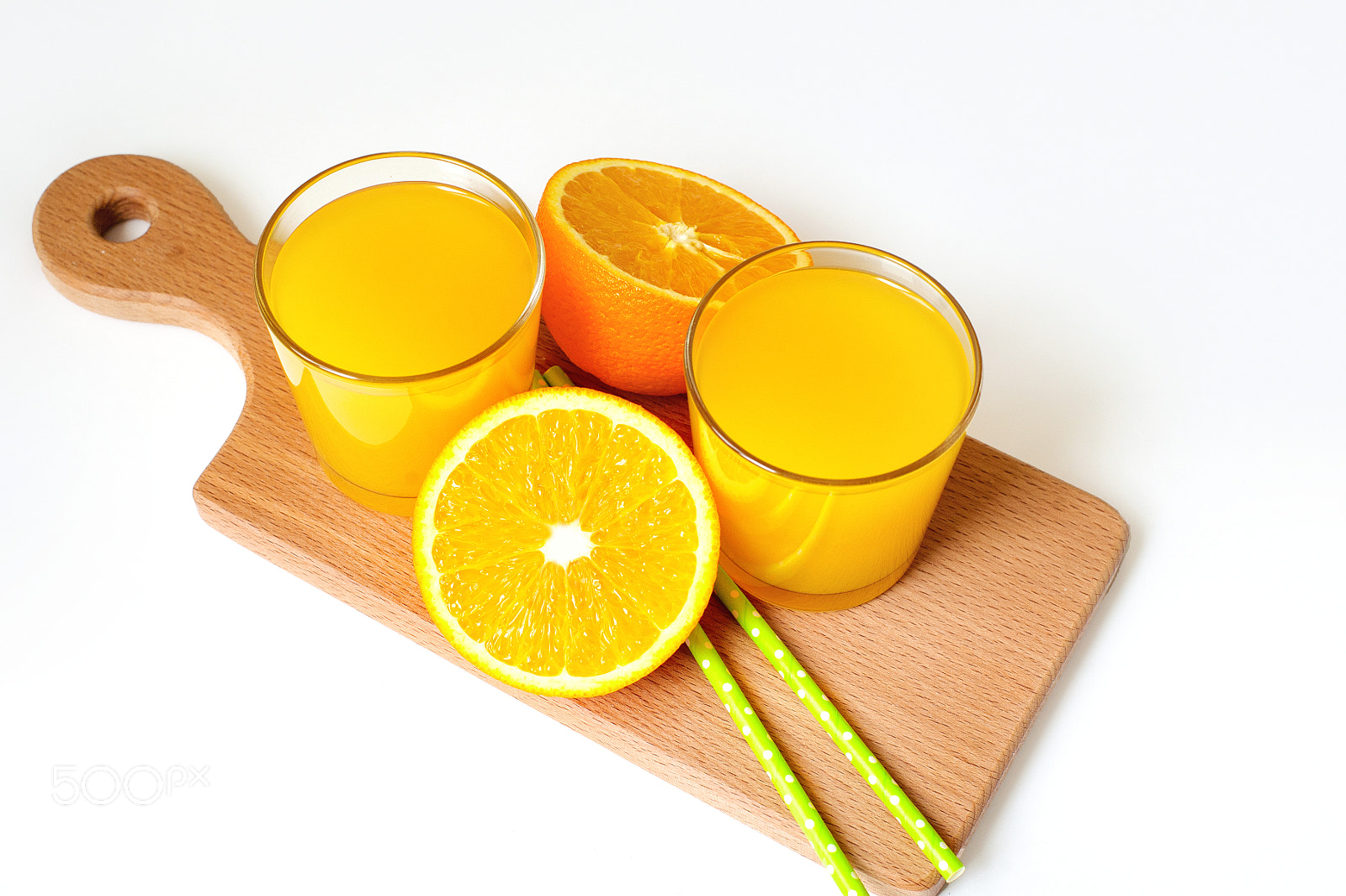 Nikon D700 sample photo. A glass of orange juice and sliced orange on the table photography
