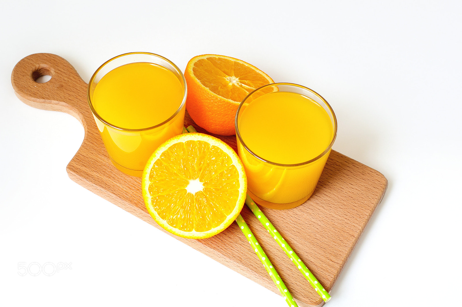 Nikon D700 + Nikon AF Nikkor 50mm F1.4D sample photo. A glass of orange juice and sliced orange on the table photography