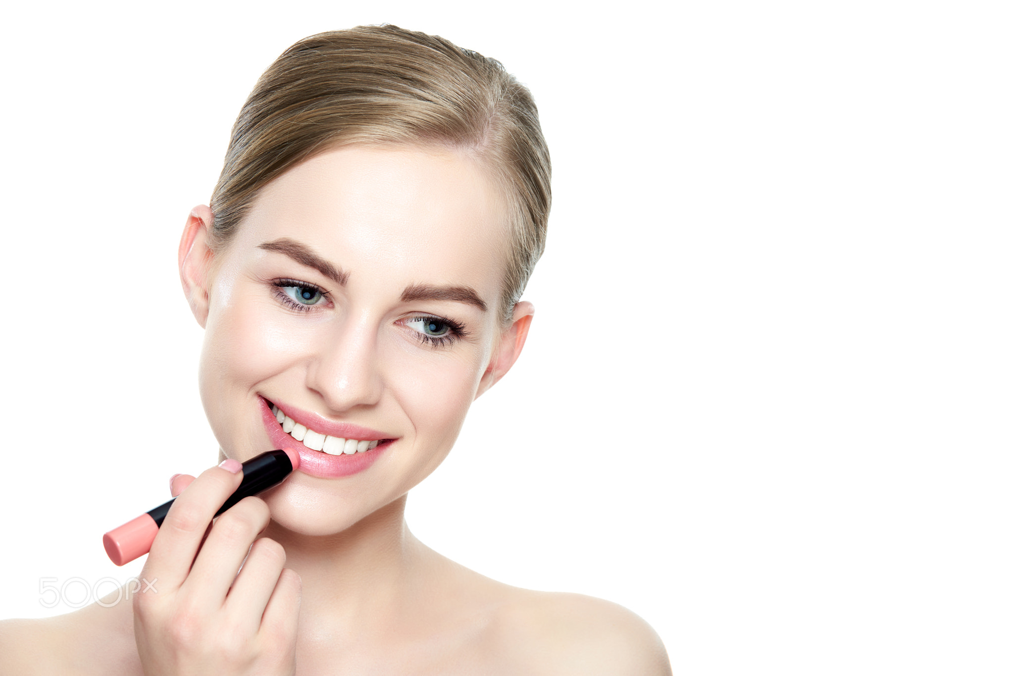 Beautiful young blond woman with sexy full lips applying coral color lipstick. Beauty portrait...
