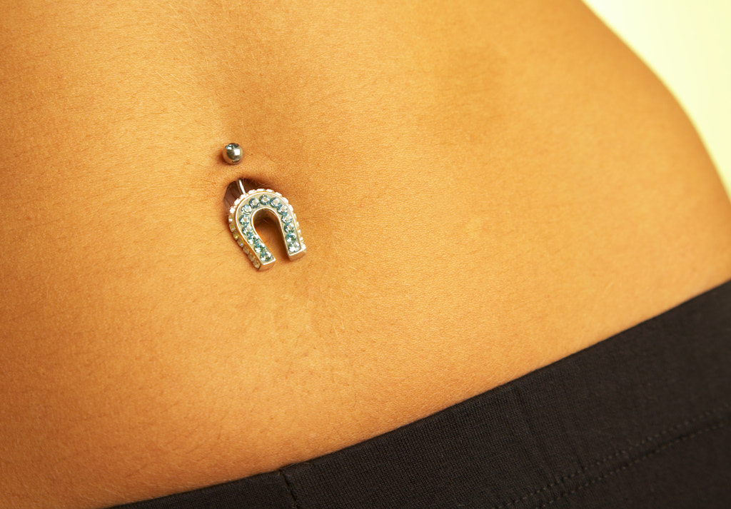 female navel with piercing by Andrey Armyagov / 500px