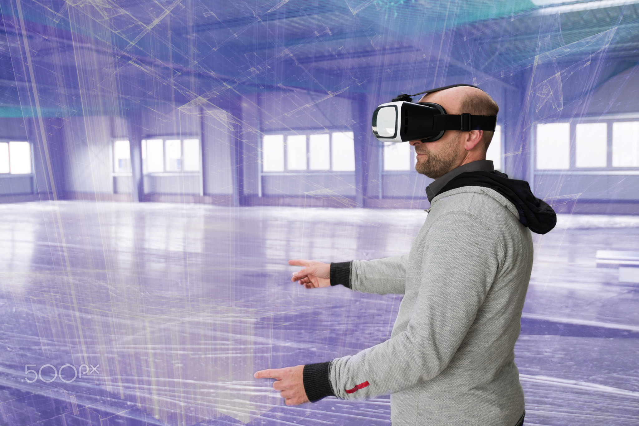 Architect with VR visor exploring industrial building environment