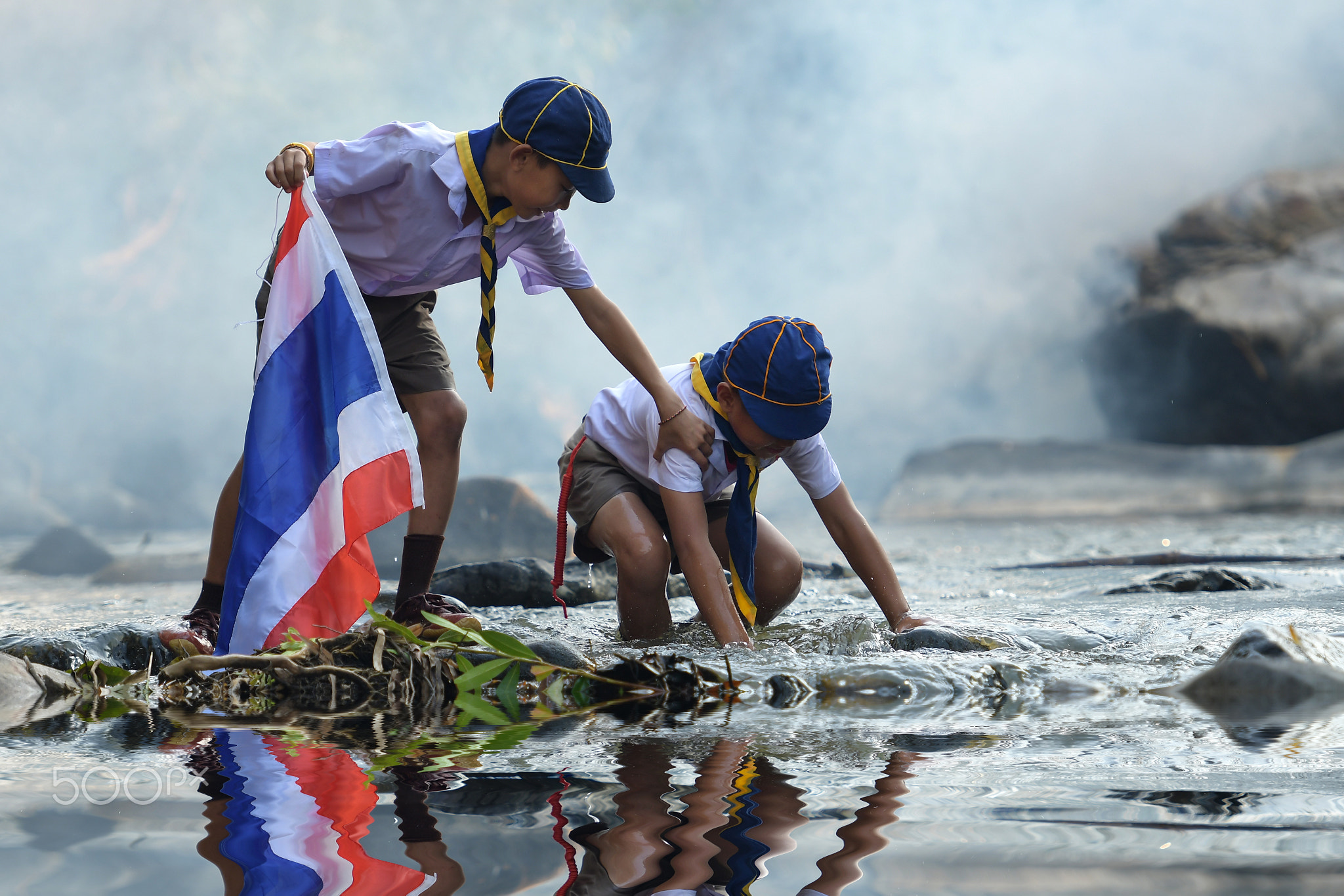 Boy scout Help each other from the river.