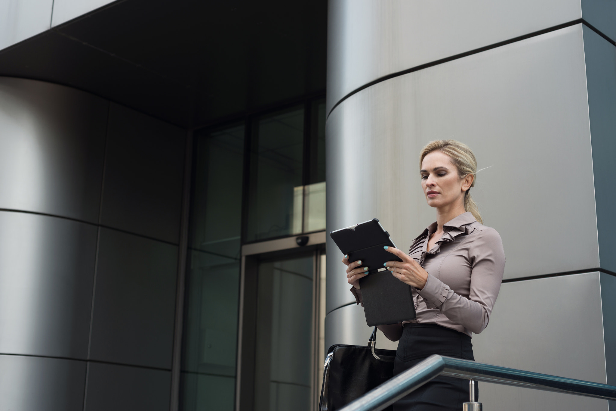 Beautiful business woman uses a digital tablet