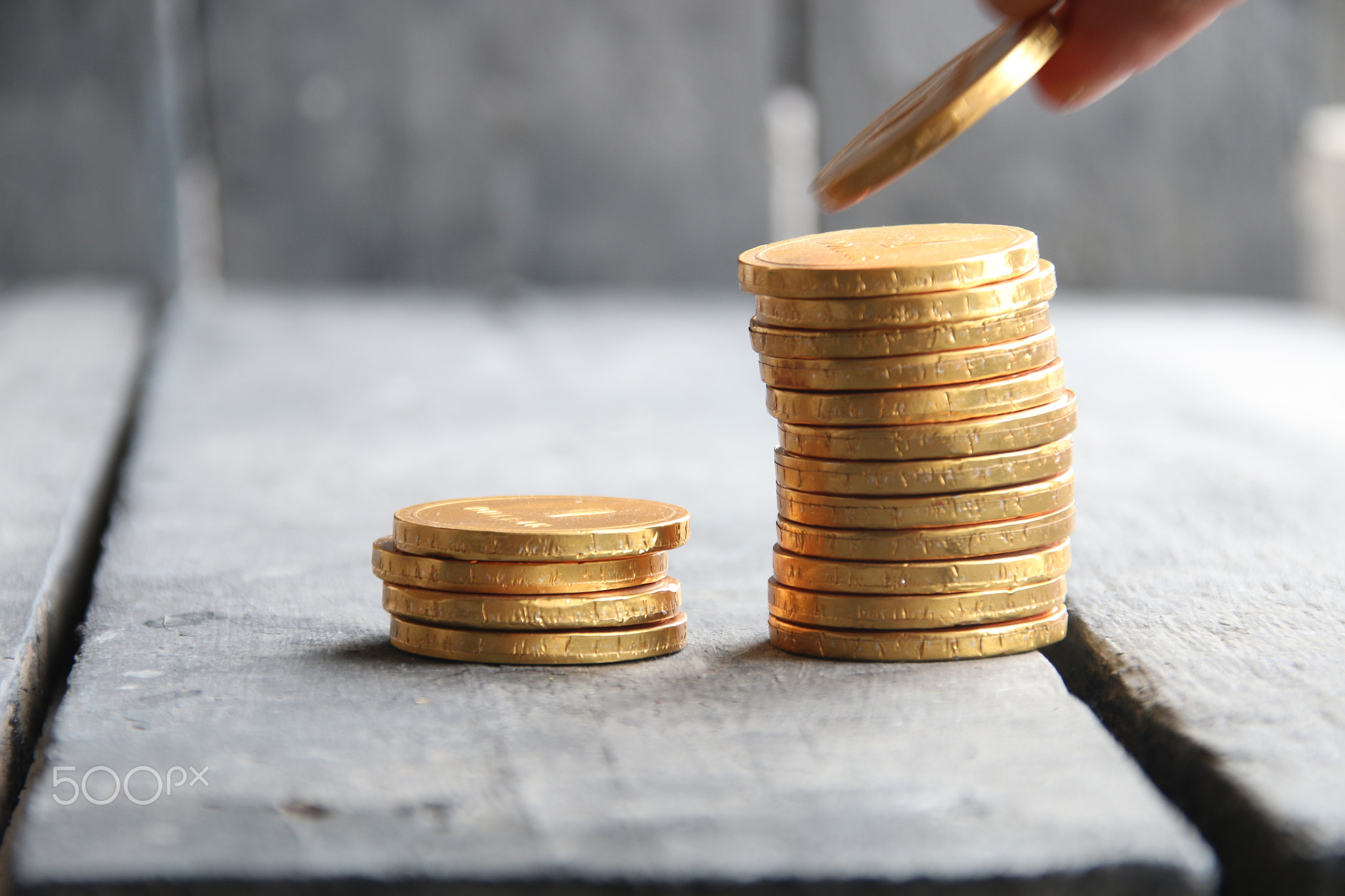 hand holding gold coins