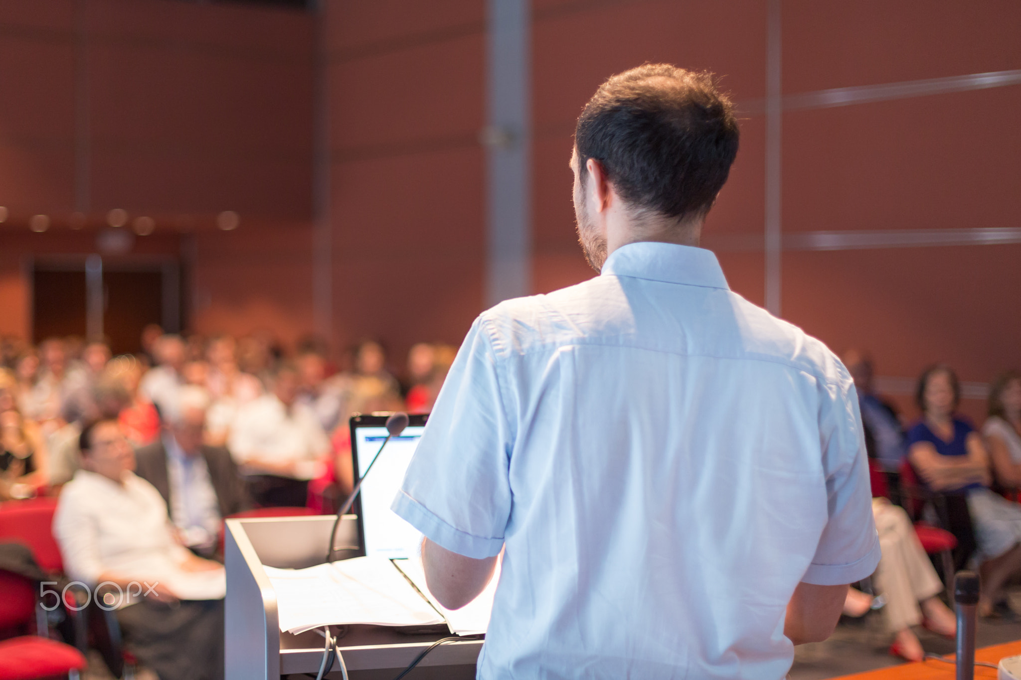 Public speaker giving talk at scientific conference.