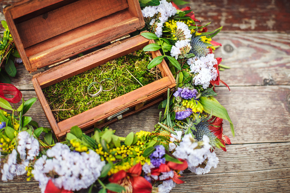 Wooden box with wedding rings in flowers