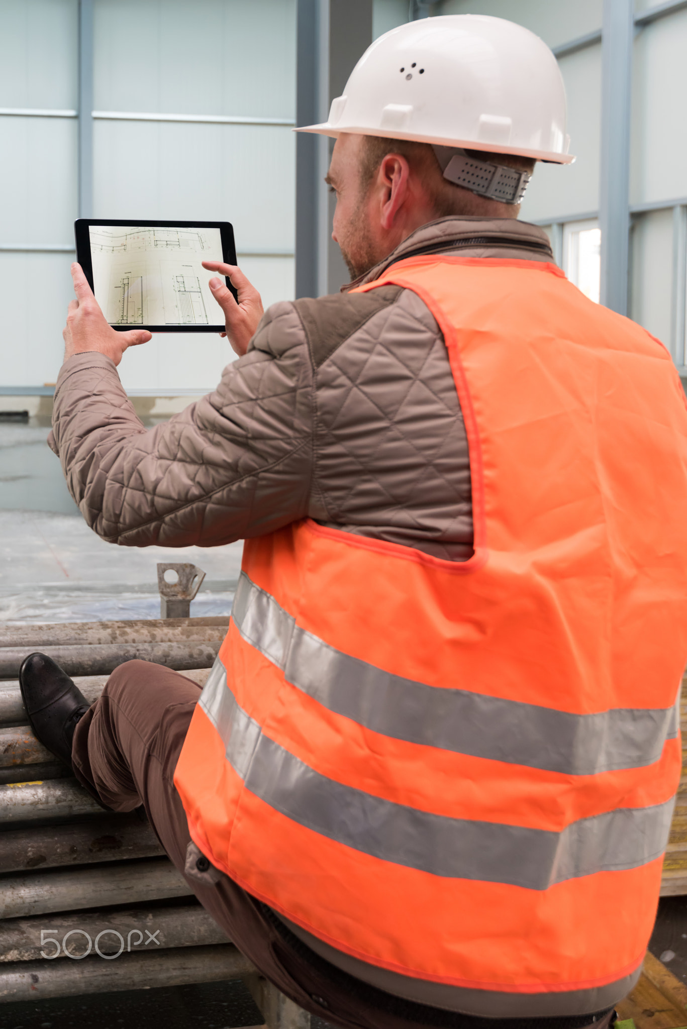 Construction supervisor with digital tablet on site