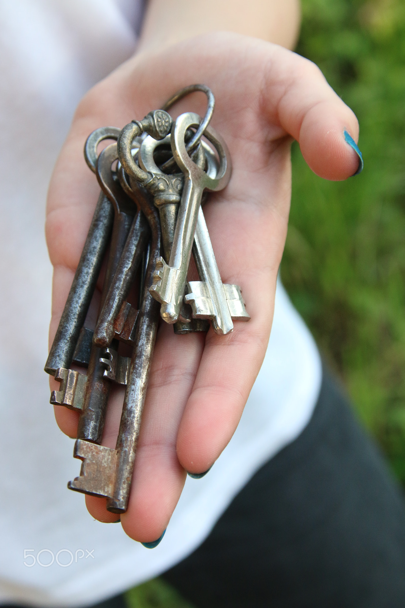 Girl holding vintage keys.
