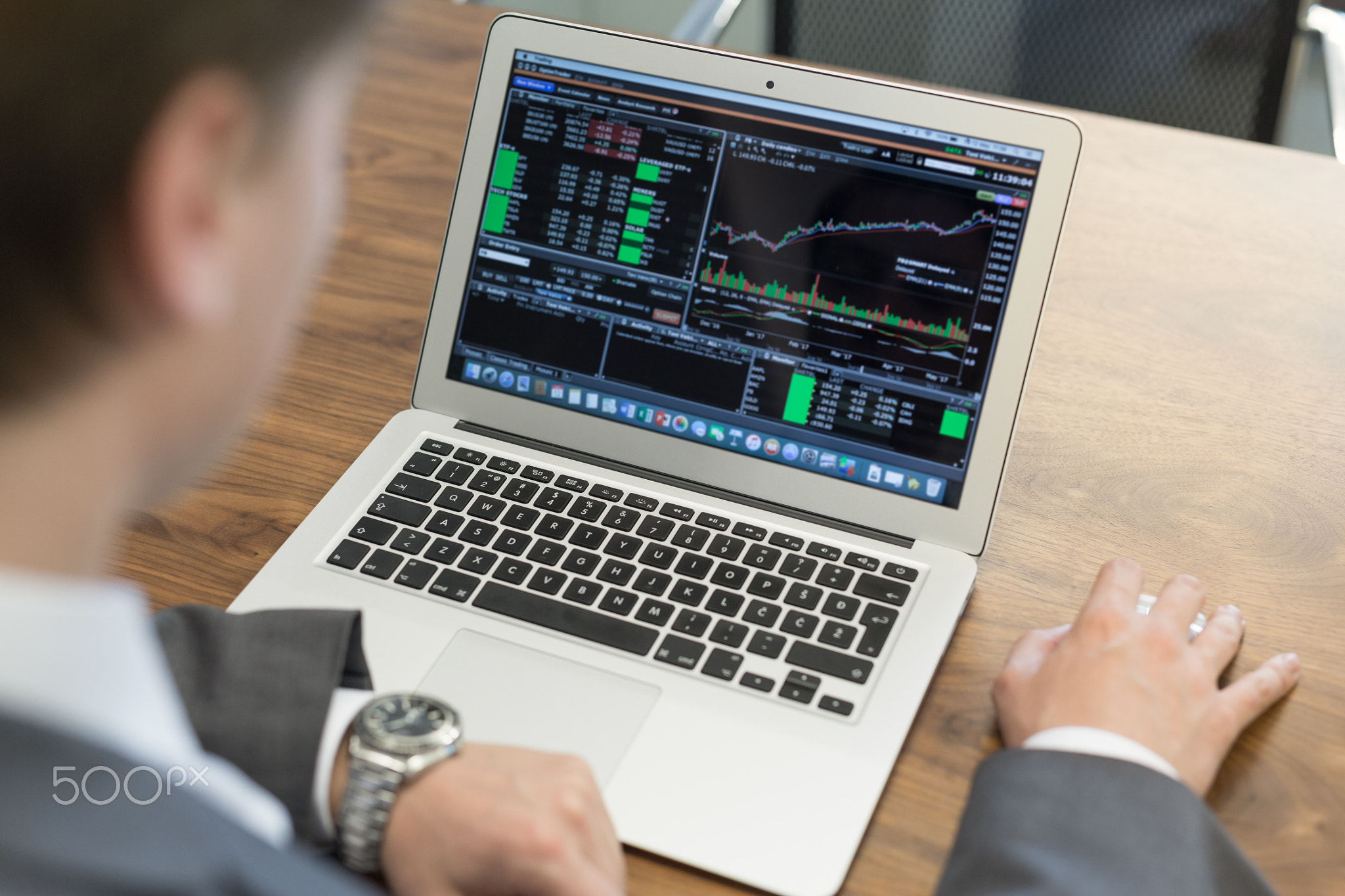 Young businessman working with laptop, man's hands on notebook computer.