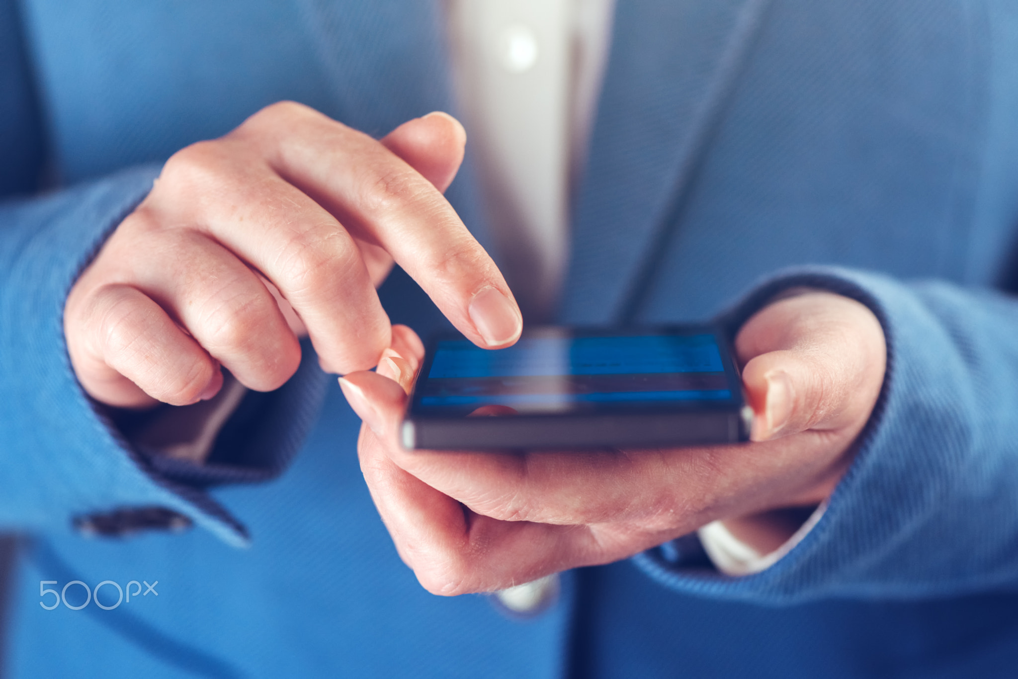 Smartphone in hands of businesswoman