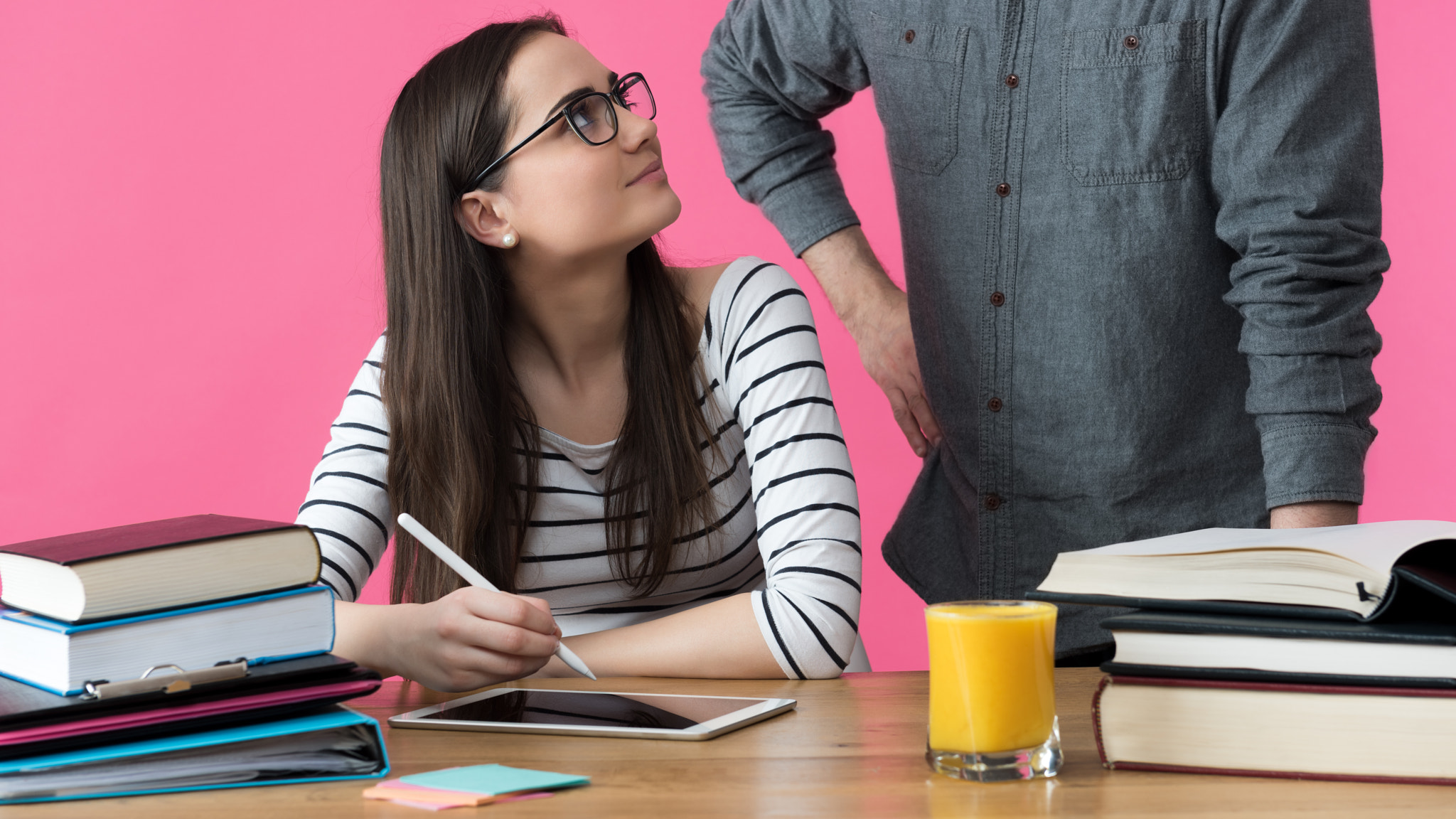 Female university student working one to one with tutor. Tutor helping student to prepare for exams