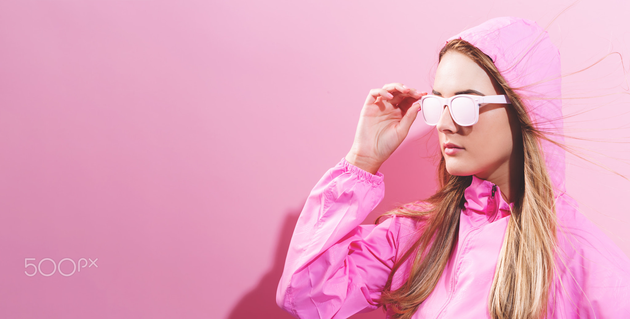 Girl in trendy painted glasses in pink jacket