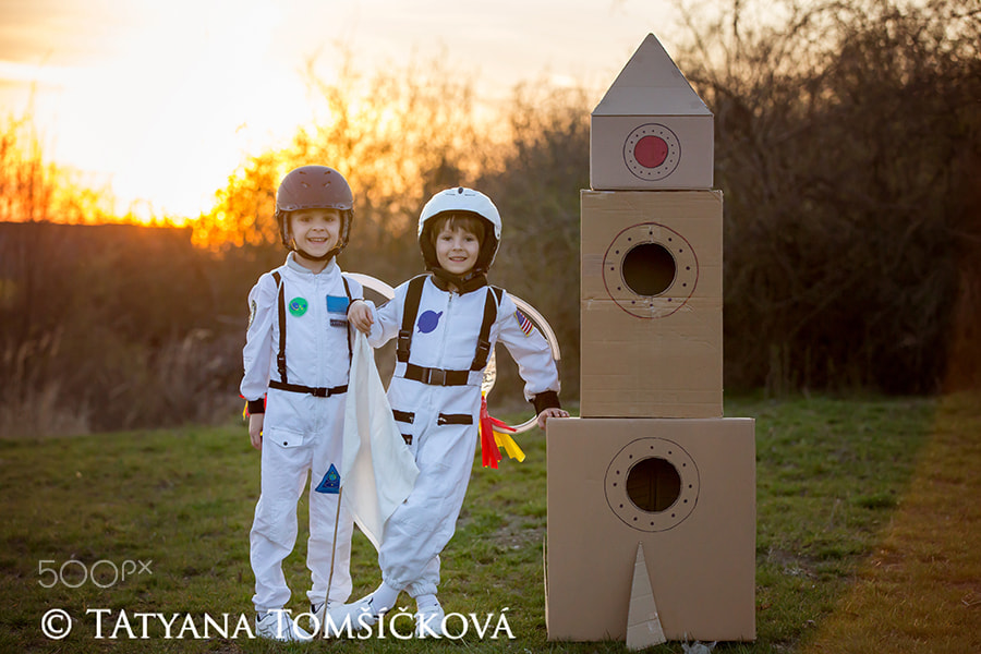 Two adorable children, playing in park on sunset, dressed like a