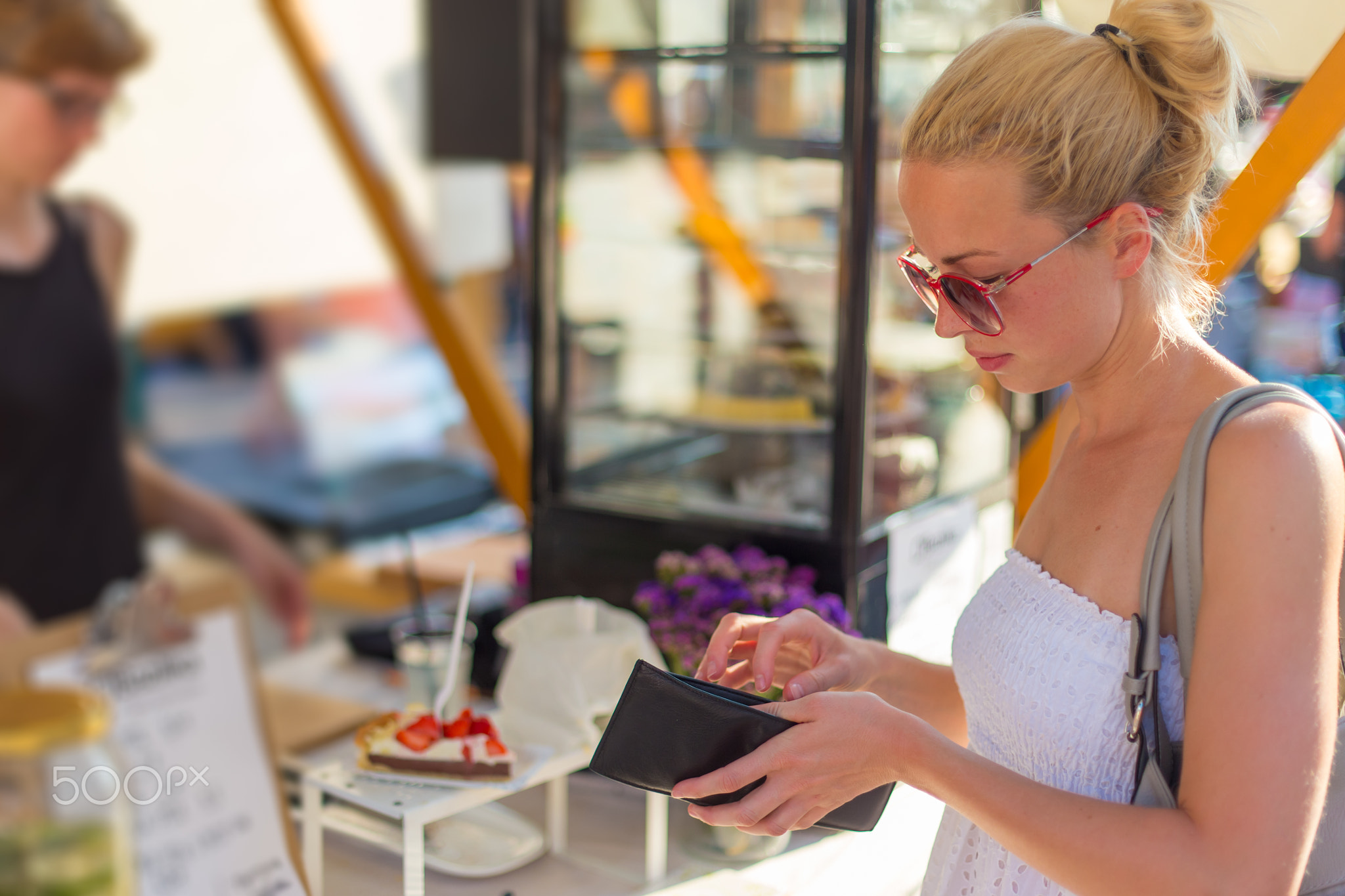 Woman buying meal at street food festival.