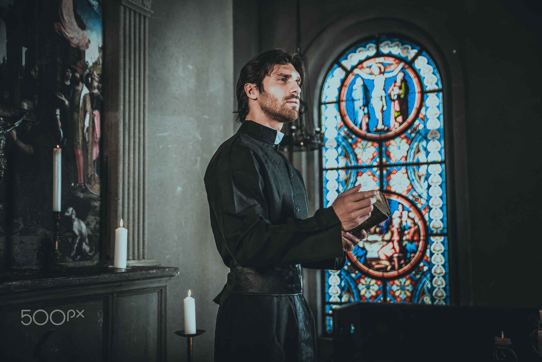 Priest reading and praying in the church