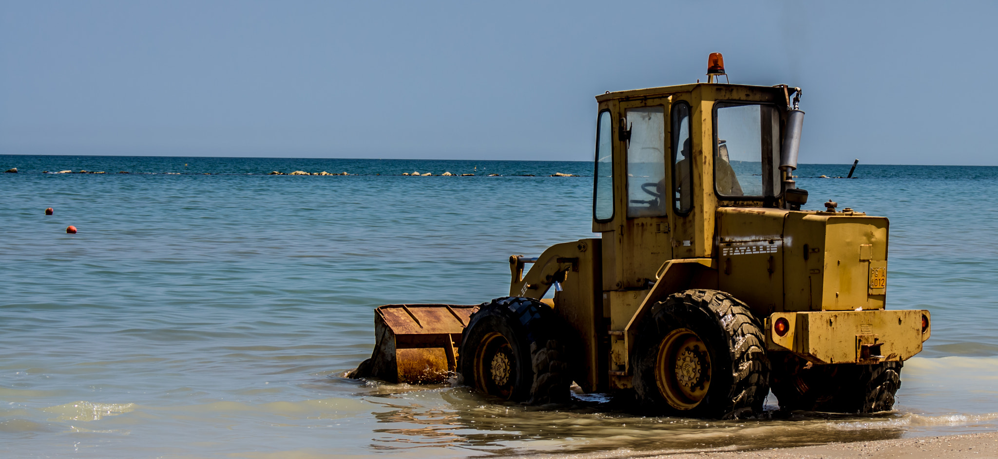 trying to hold back the tide with a broom(scraper) by Gabriele