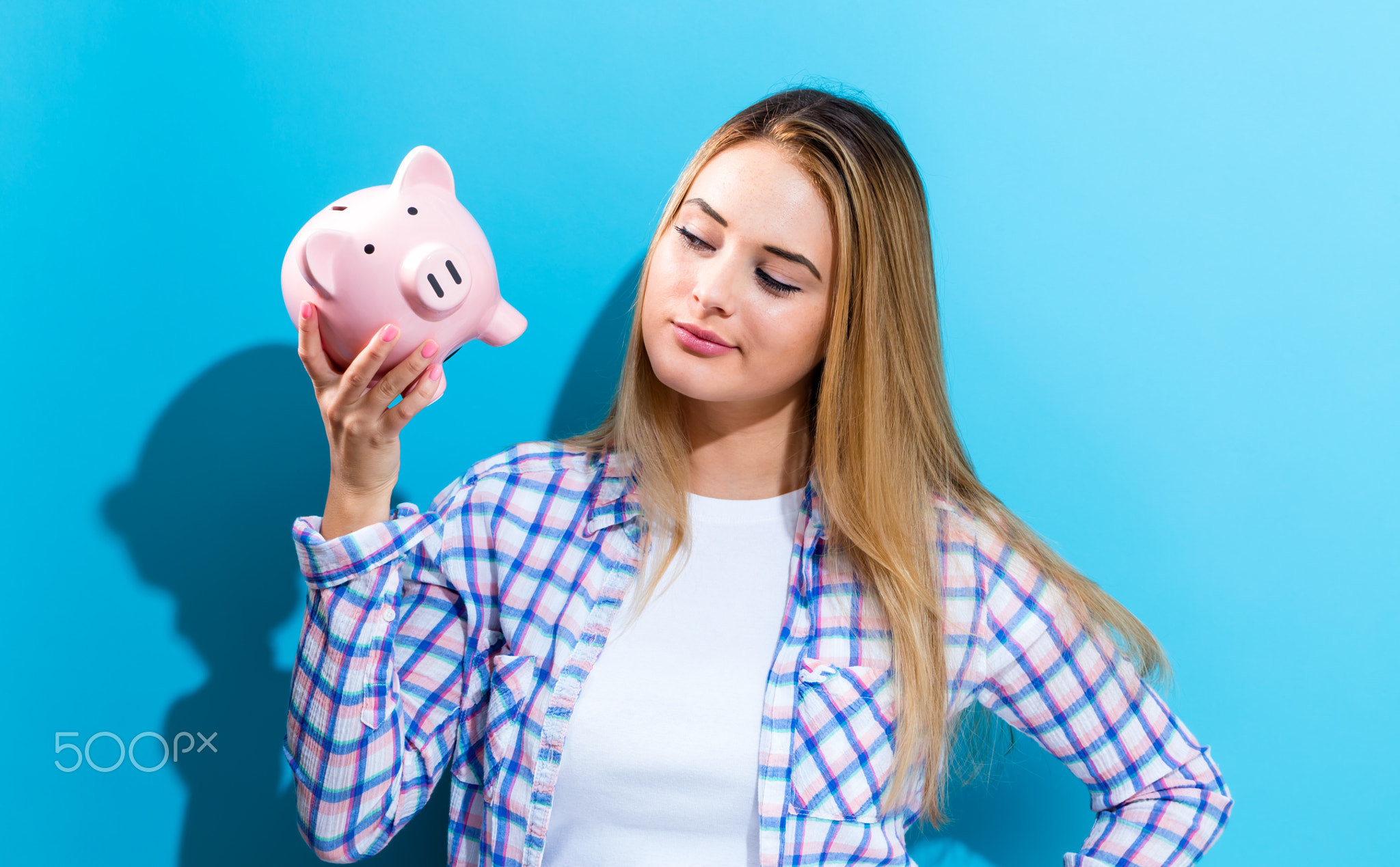 Woman holding piggy bank