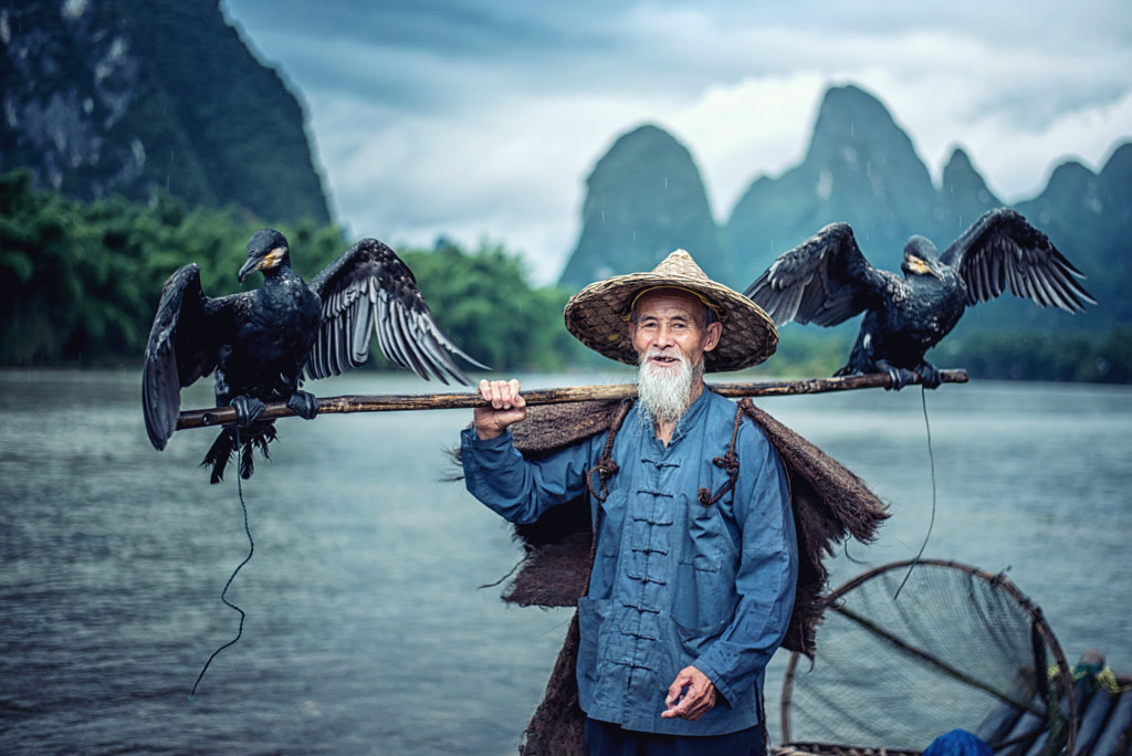 Cormorant fisherman in Traditional showing of his birds on Li ri by Chanwit Whanset on 500px.com