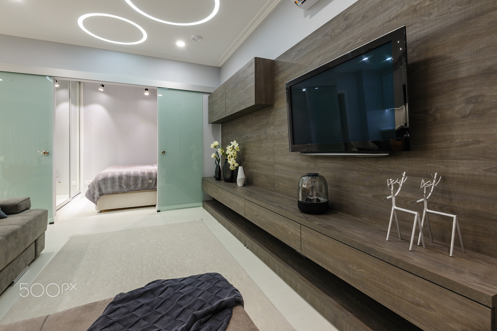 Modern white living studio with bedroom doors open
